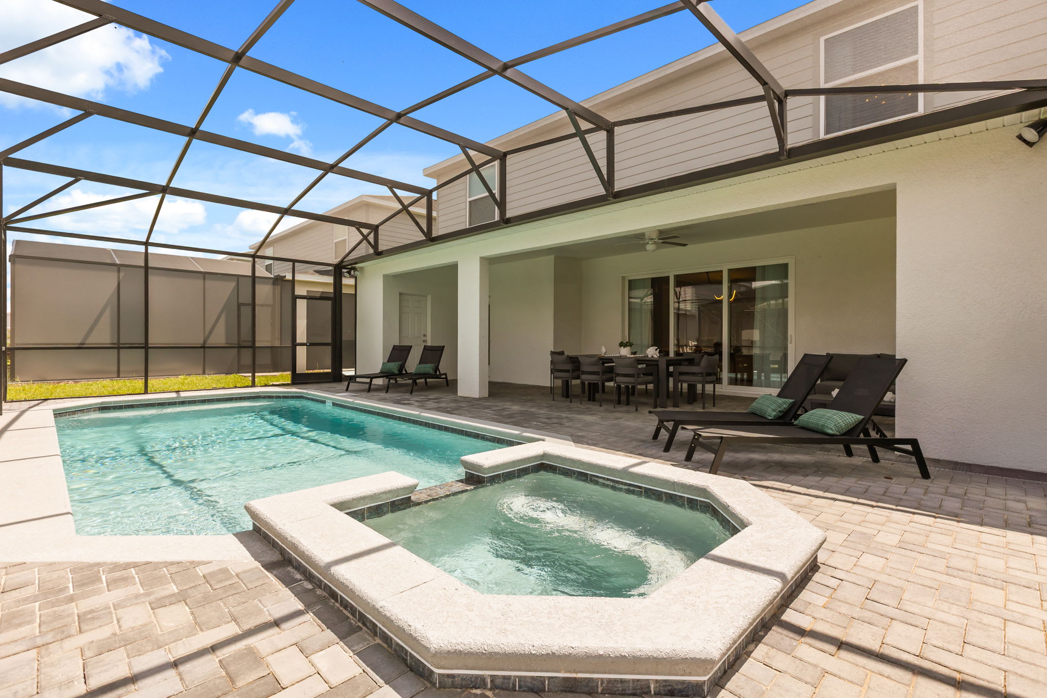 Relax in your private pool and hot tub oasis, complete with a spacious patio and dining area for ultimate outdoor enjoyment.