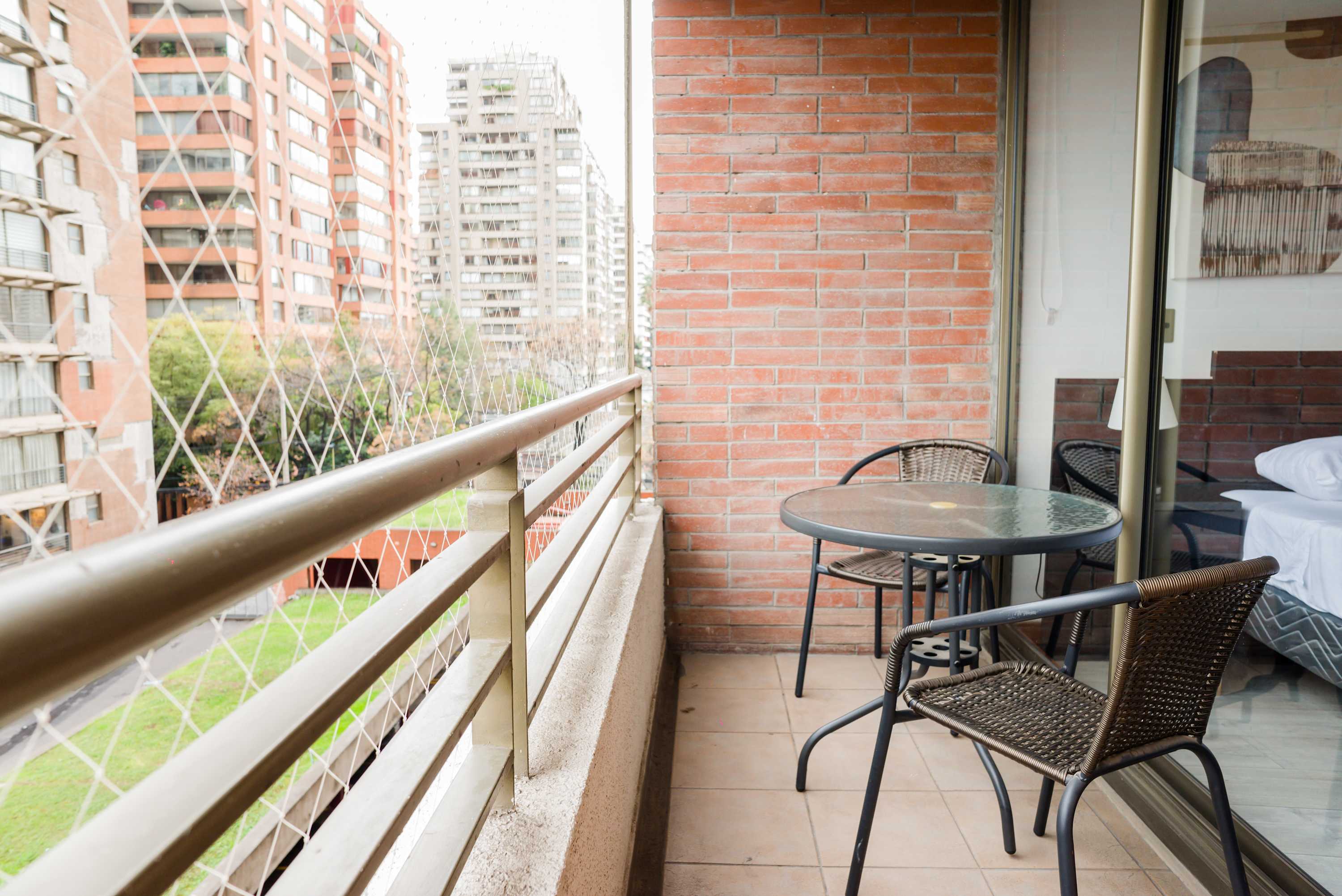 Relax on your private balcony with a cozy seating area and enjoy views of the cityscape.