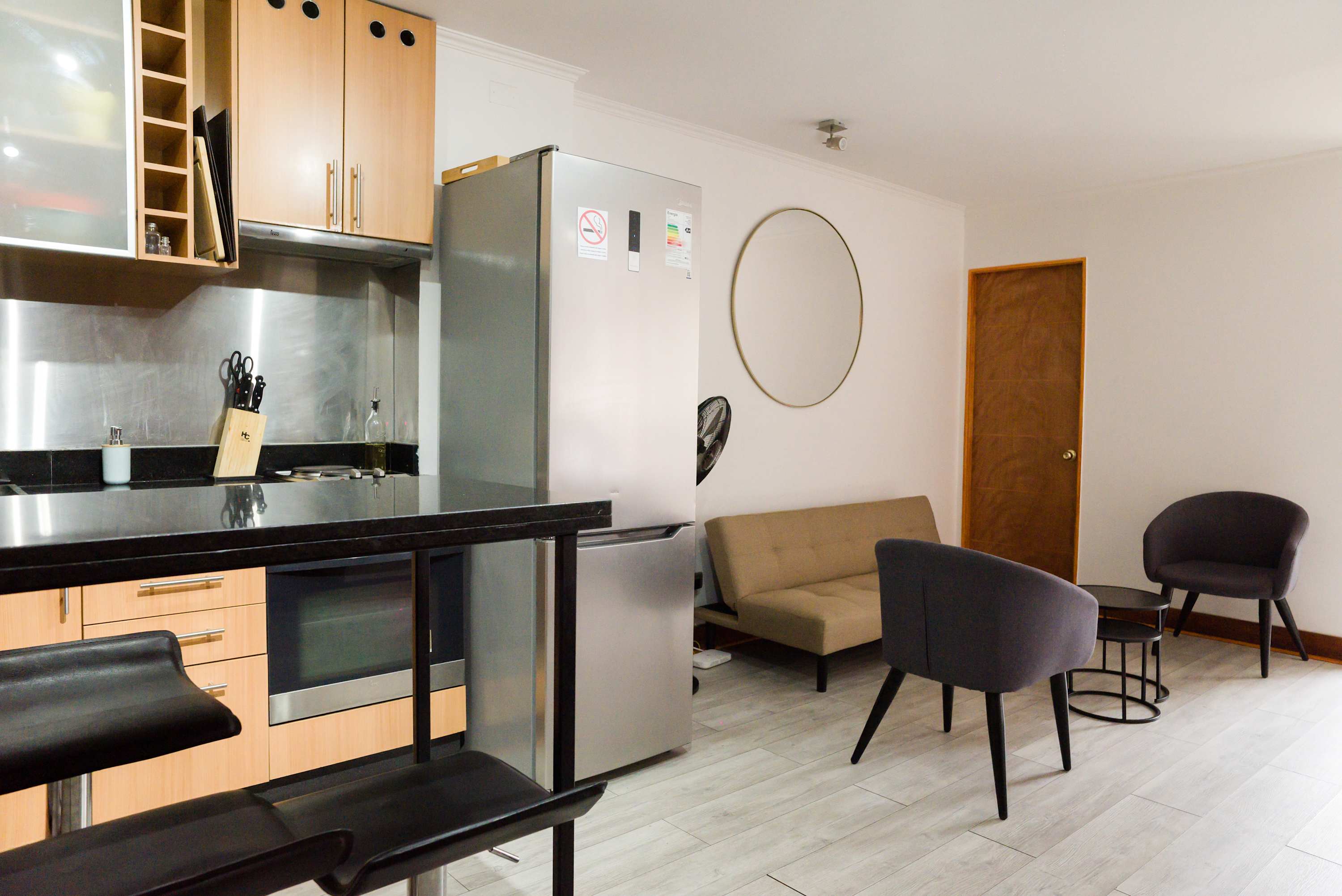 Cozy living area with modern kitchen and stylish seating, perfect for relaxation after exploring the city.