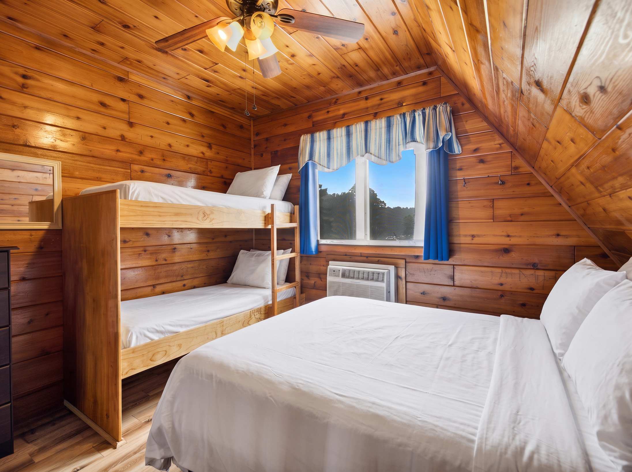 Queen bedroom with built in twin bunk beds offers flexible sleeping space.