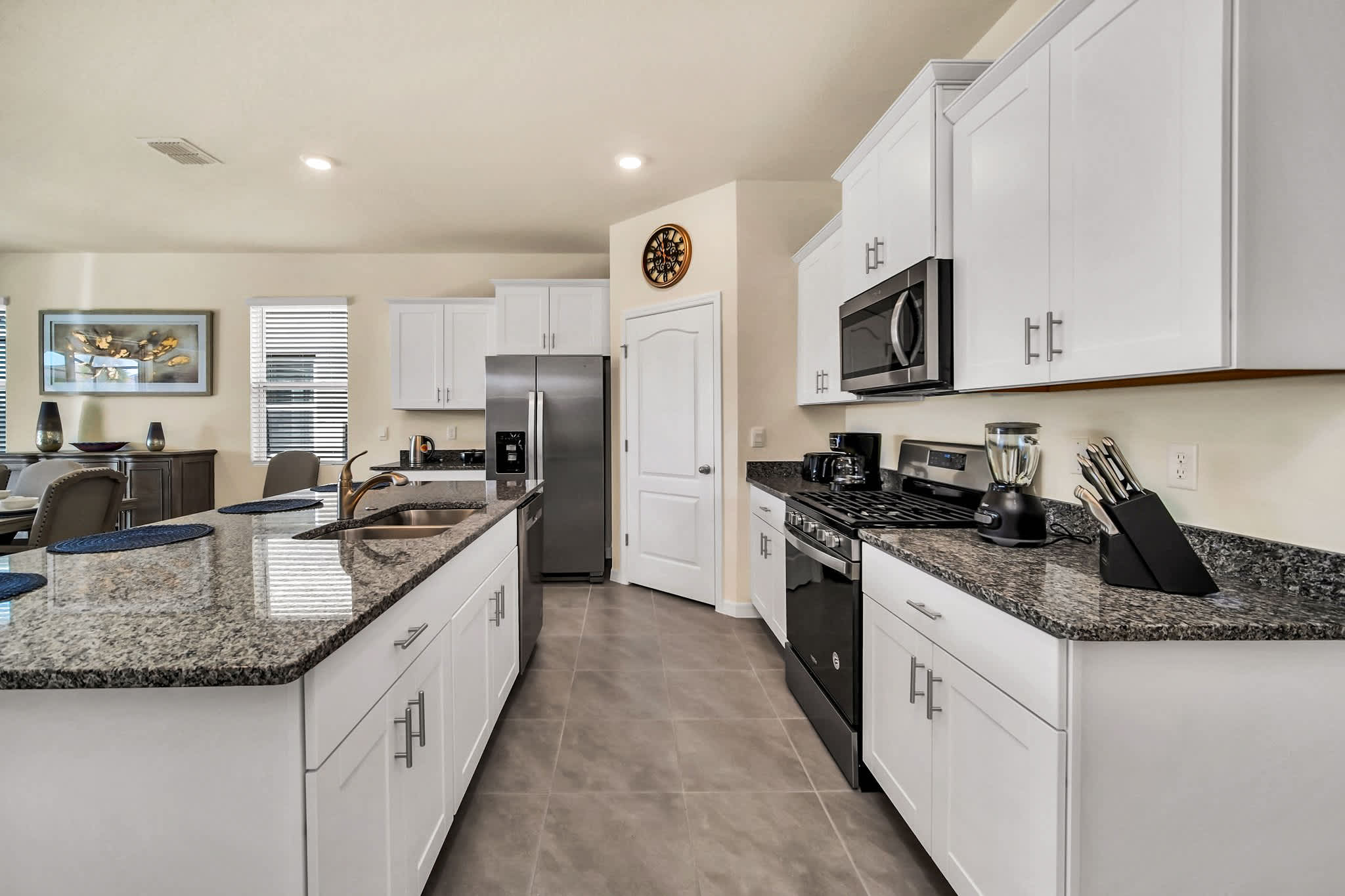 Spacious modern kitchen with sleek granite countertops and stainless steel appliances, perfect for culinary adventures.