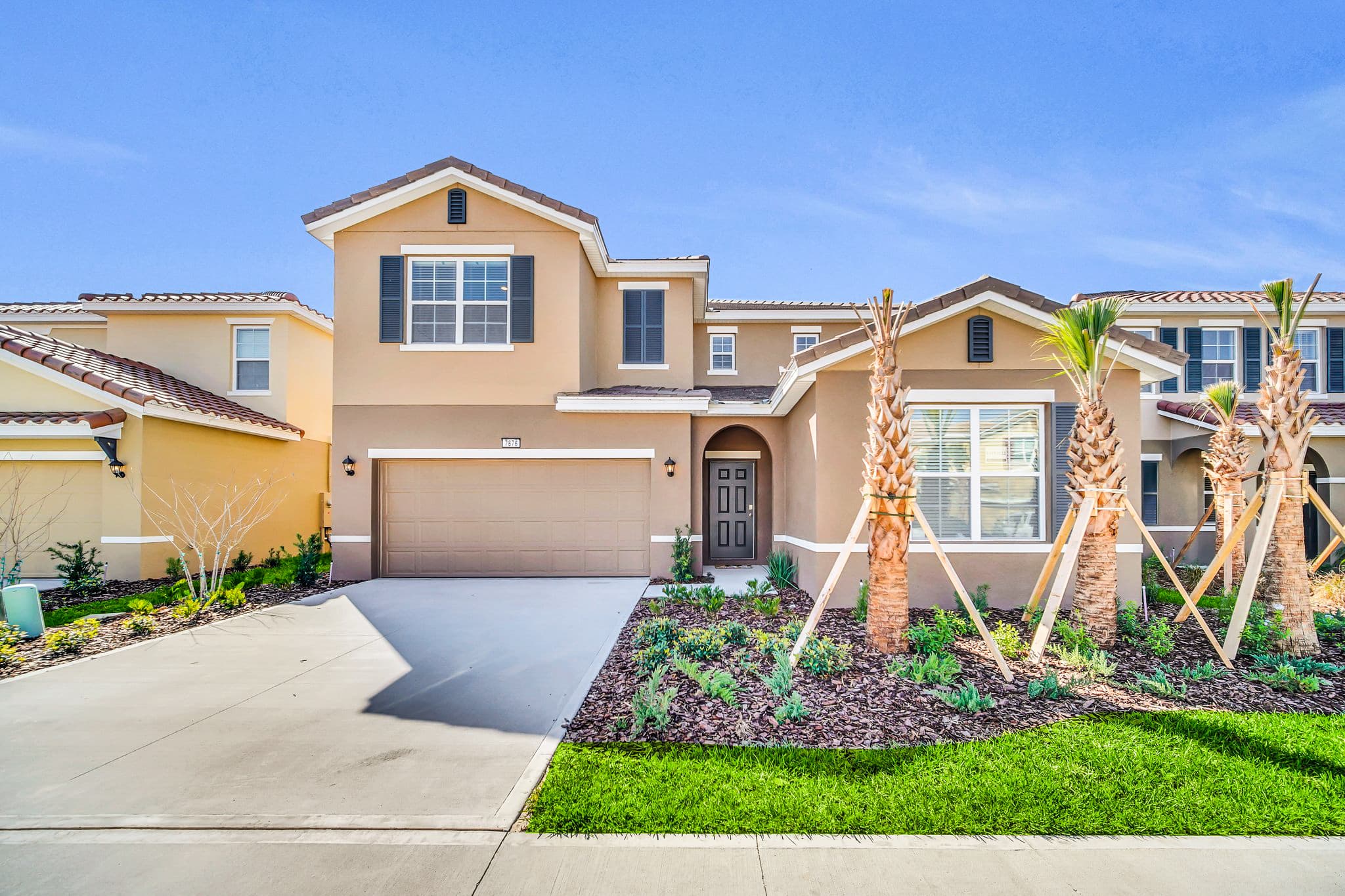 Spacious villa with modern design and lush landscaping, perfect for a relaxing getaway.