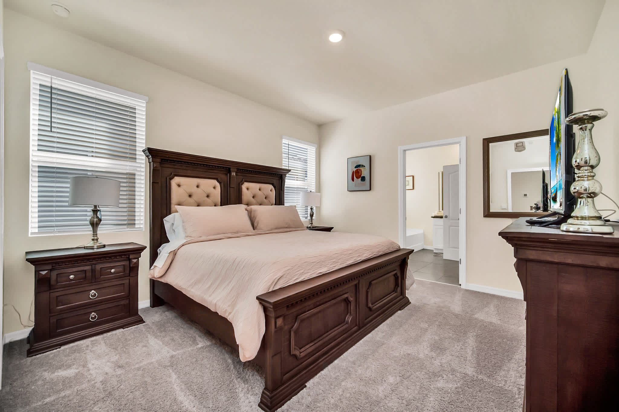 Relax in this elegant bedroom featuring a luxurious king-sized bed and en-suite bathroom, perfect for unwinding after a day of exploring.