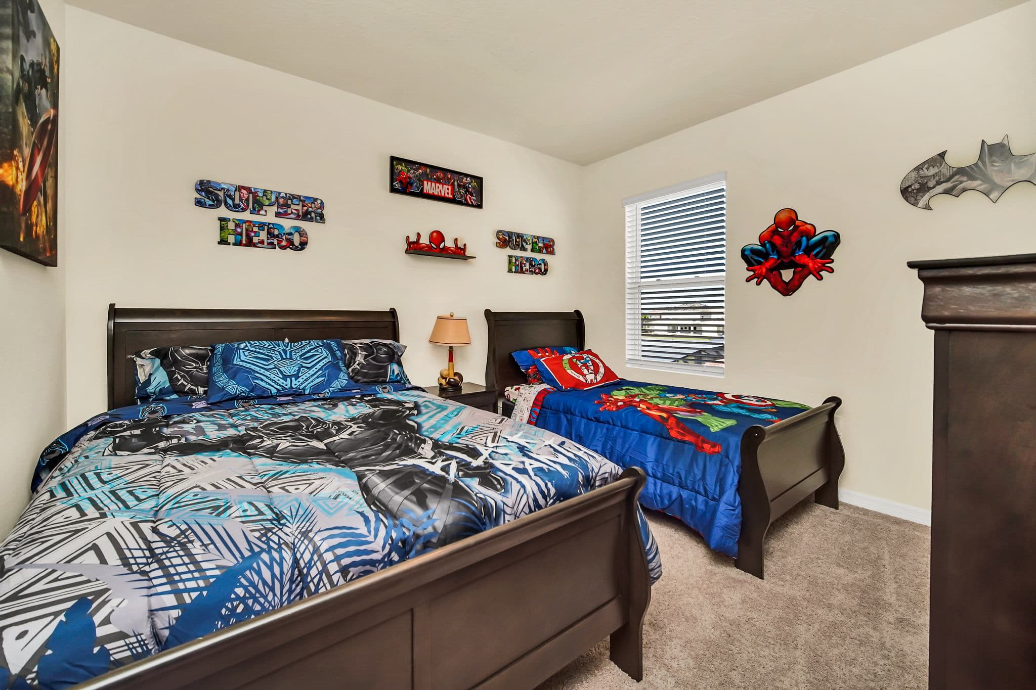 Exciting superhero-themed bedroom perfect for kids, featuring vibrant decor and cozy beds.