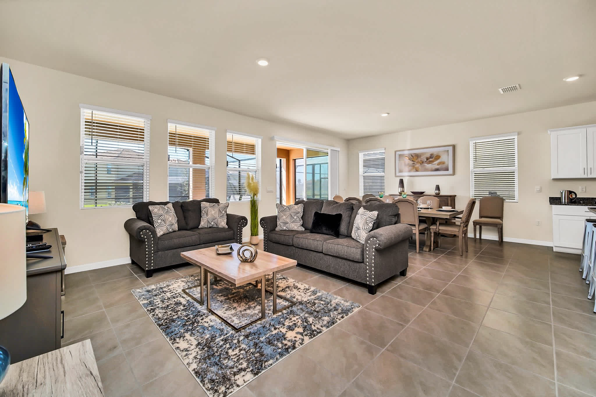 Relax in this spacious living area with ample seating and natural light, perfect for gatherings.