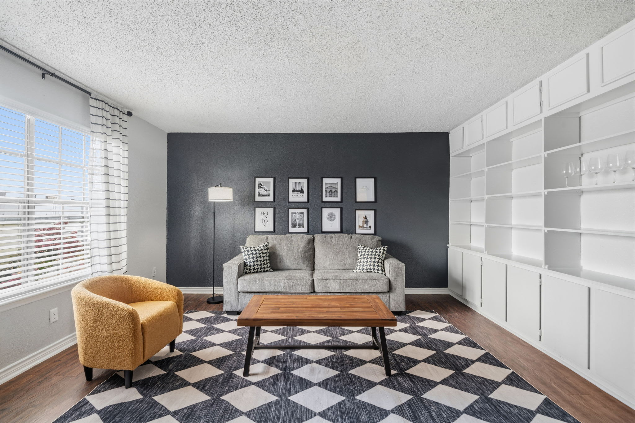 Stylish living room with cozy seating, chic decor, and ample natural light, perfect for relaxation.
