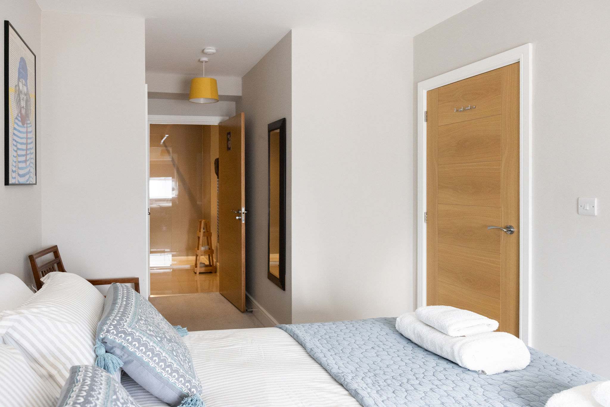 Spacious king bedroom with ensuite access, offering comfort for a relaxing coastal escape