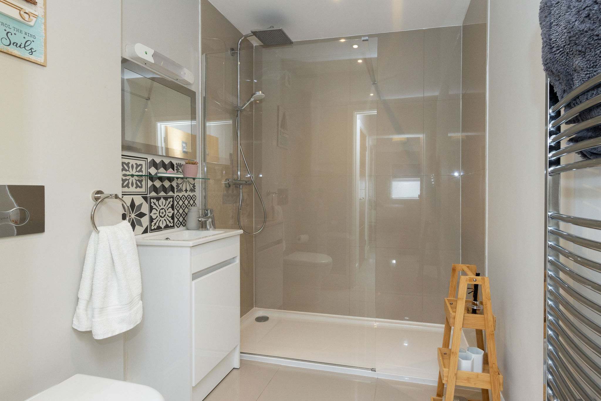 Modern walk-in shower room with contemporary finishes, adding comfort to your relaxing coastal stay
