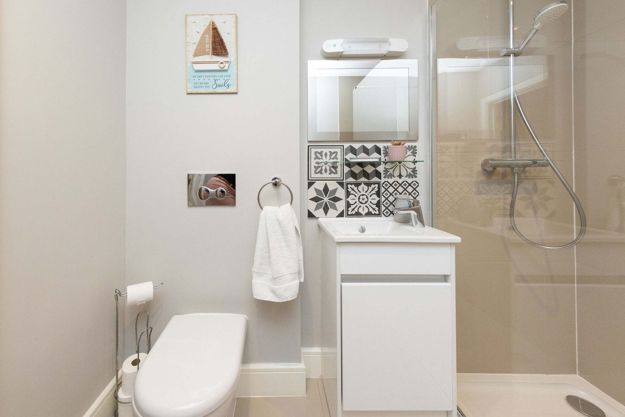Modern ensuite shower room with stylish finishes for added comfort during your seaside stay