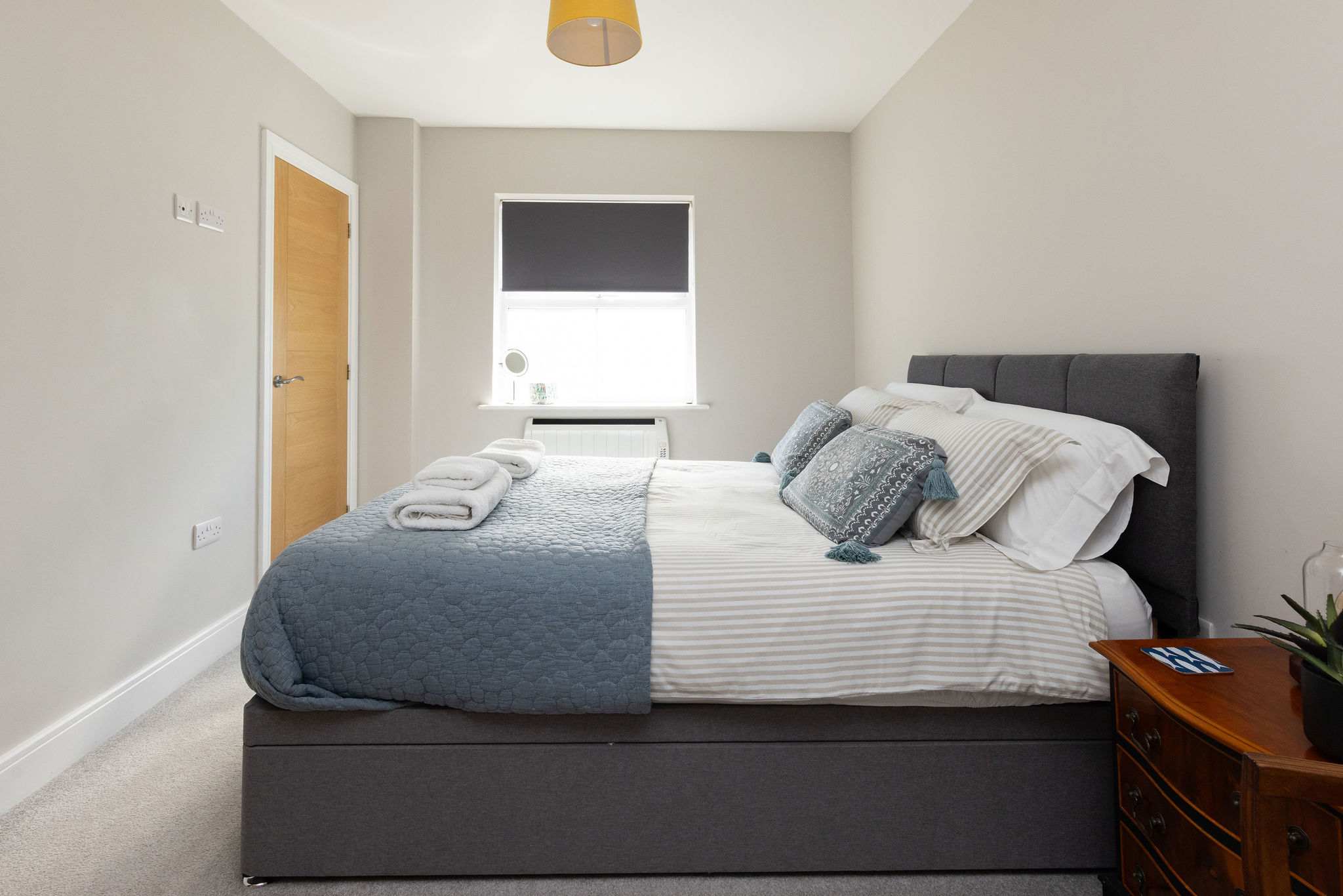 Bright king bedroom with comfortable furnishings, perfect for a peaceful seaside holiday retreat