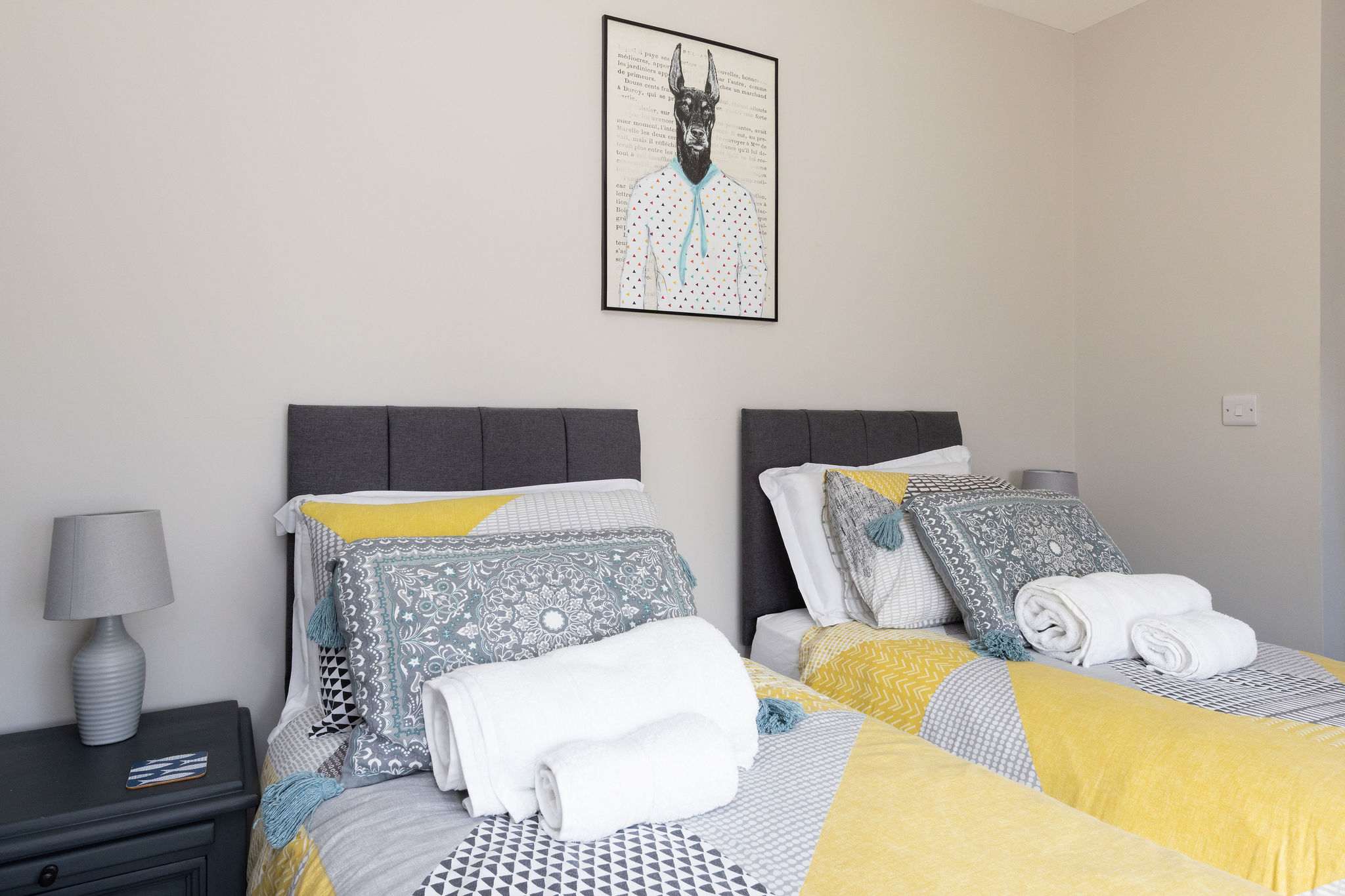 Comfortable twin bedroom with soft furnishings, ideal for families and friends enjoying coastal breaks