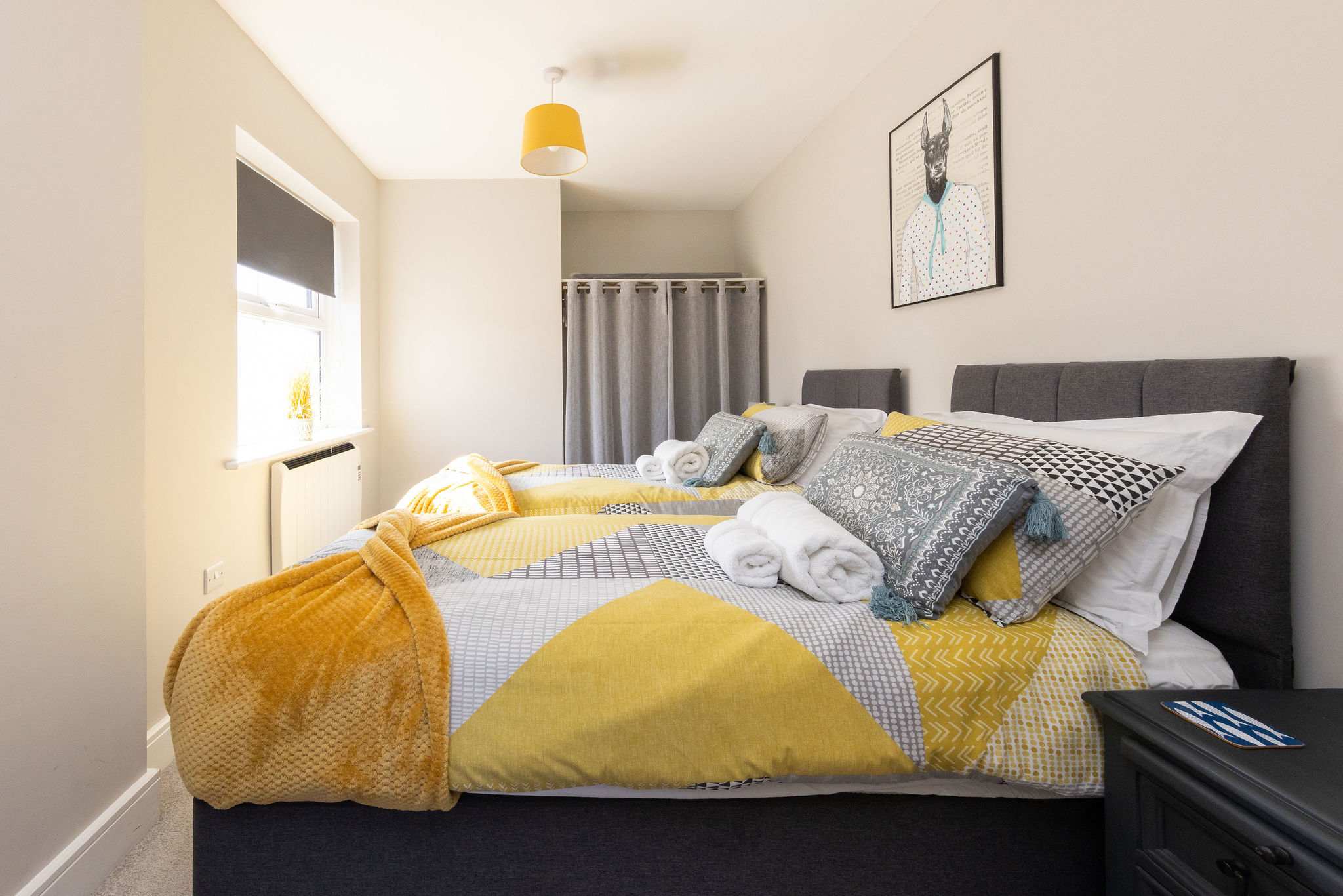 Bright twin bedroom with comfortable beds, ideal for families or friends enjoying a seaside getaway