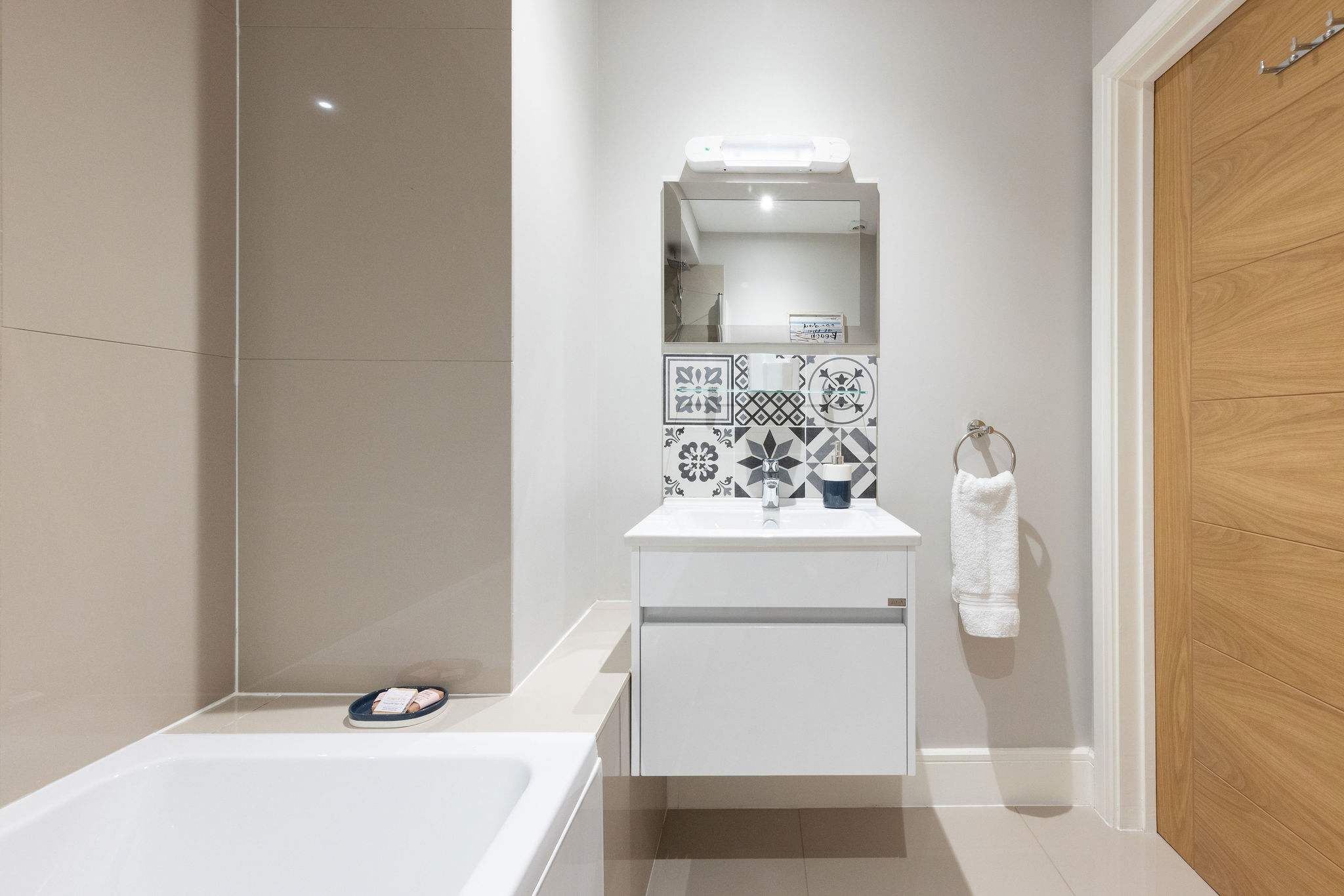 Modern family bathroom with stylish vanity, offering added comfort for your seaside holiday