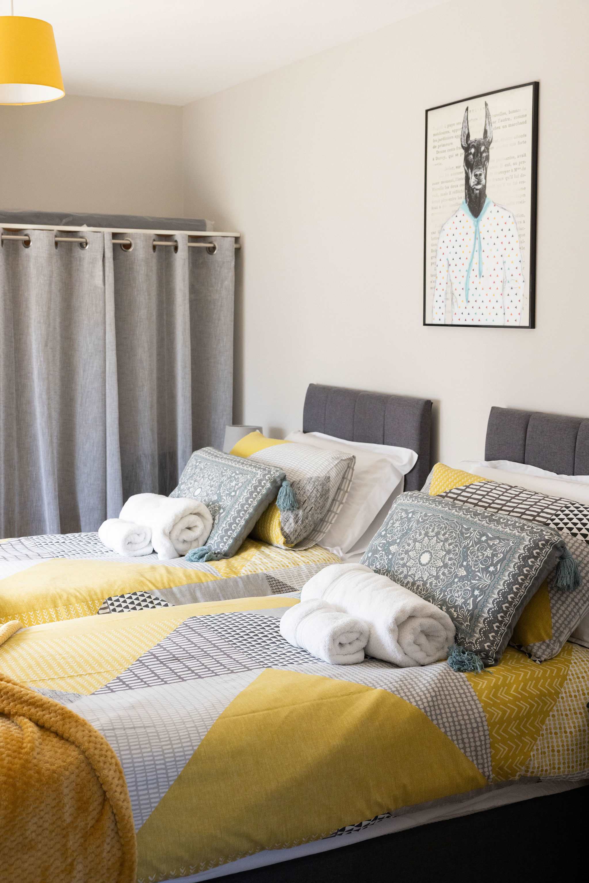 Comfortable twin bedroom with stylish décor, perfect for a relaxing family coastal retreat