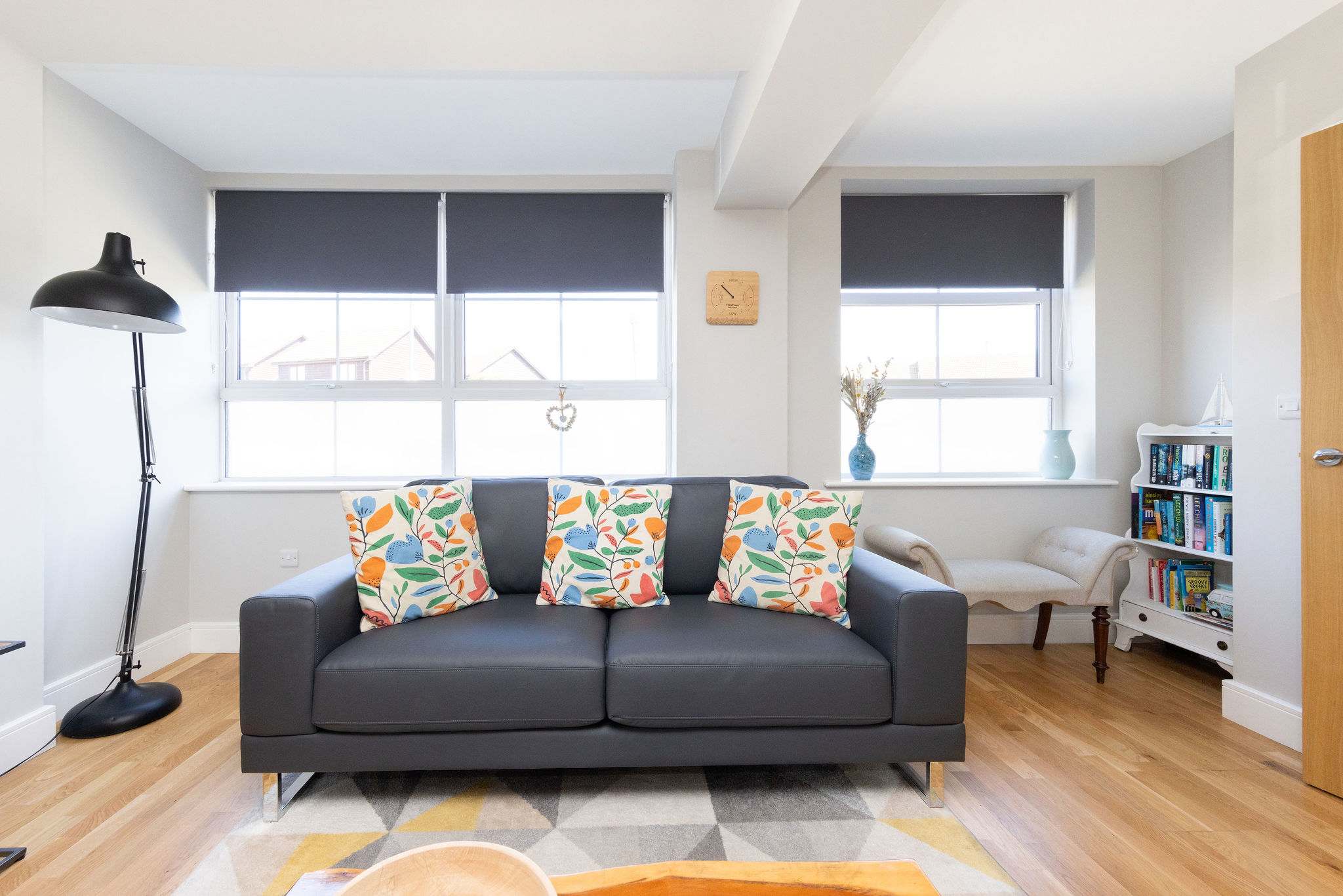 Comfortable lounge with bright natural light, perfect for a relaxing seaside holiday home