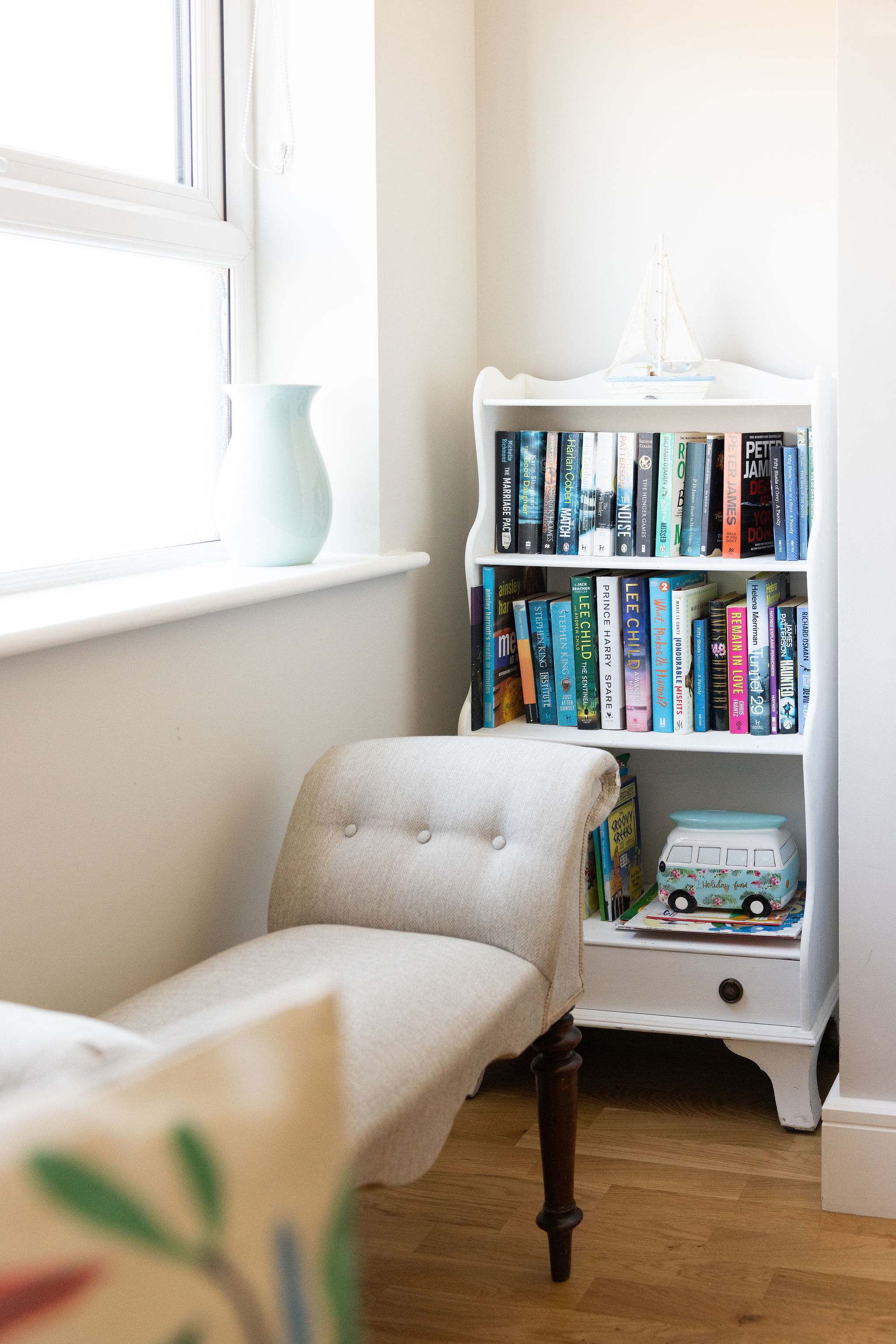 Cosy reading corner with books, creating a peaceful space to unwind during your coastal stay