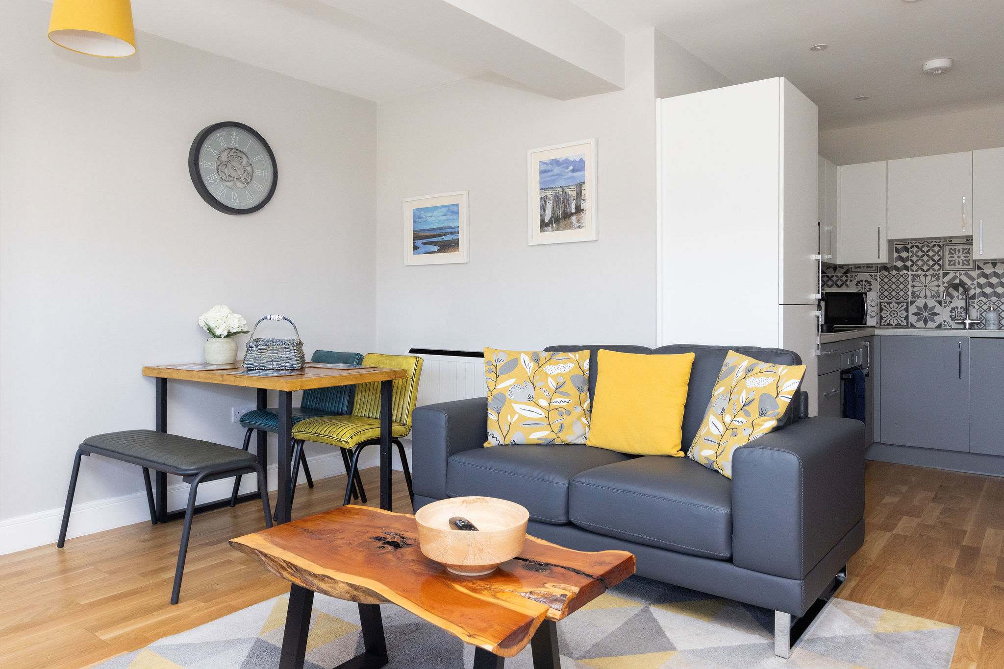 Stylish open-plan living space combining lounge, dining area and modern fully equipped kitchen