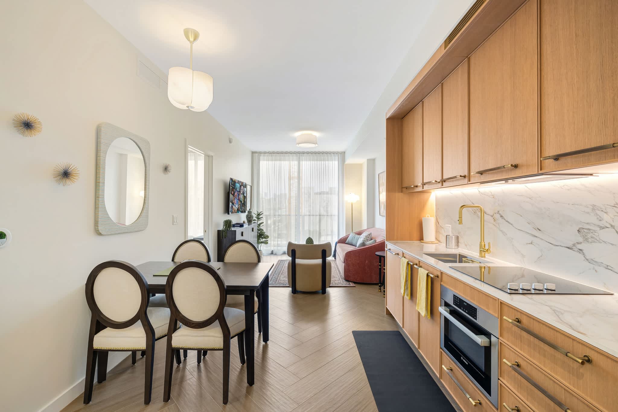 Experience modern living in this stylish apartment with a sleek kitchen and cozy dining area.