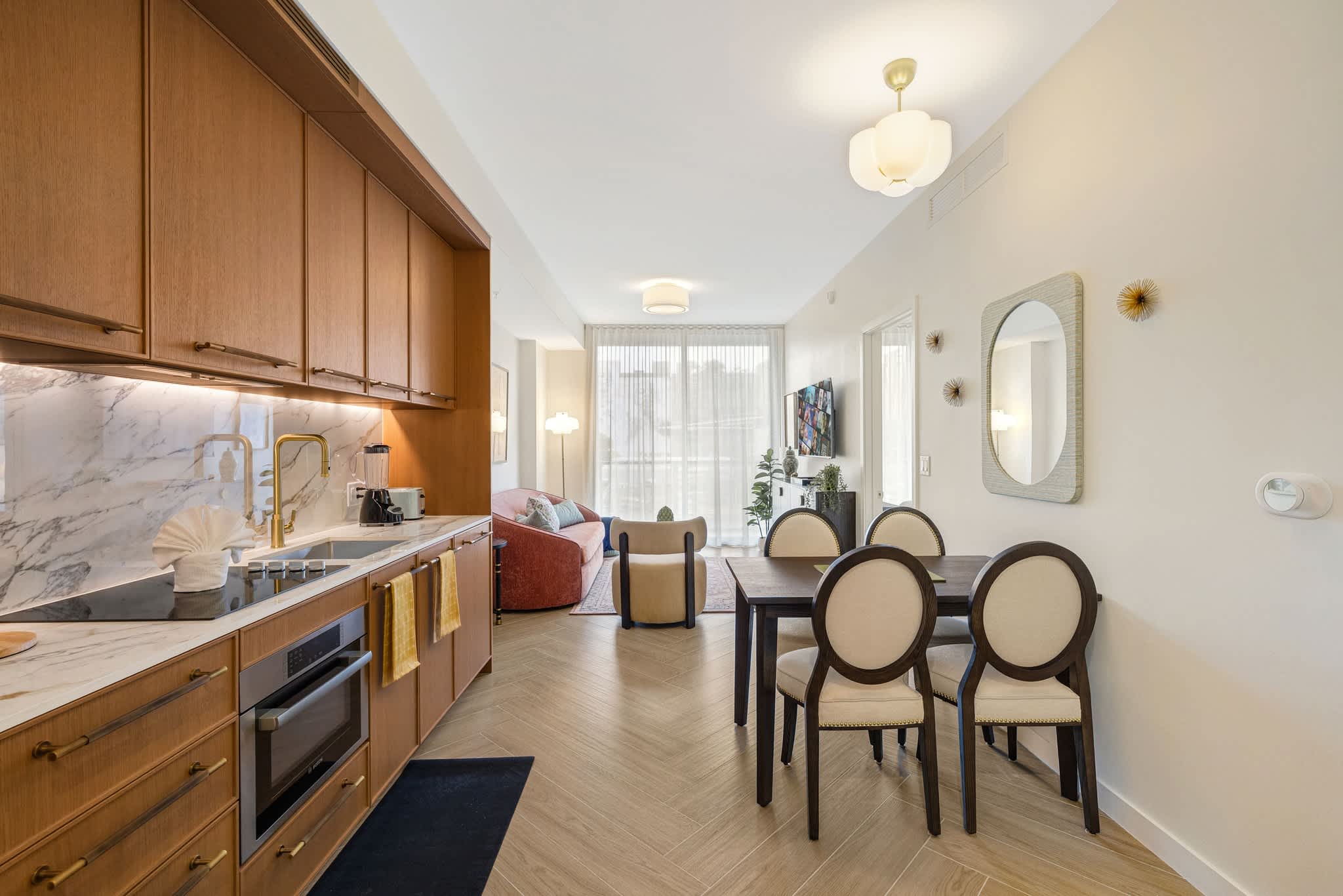 Experience modern comfort in this stylish studio with a sleek kitchen and cozy dining area, perfect for a relaxing stay.