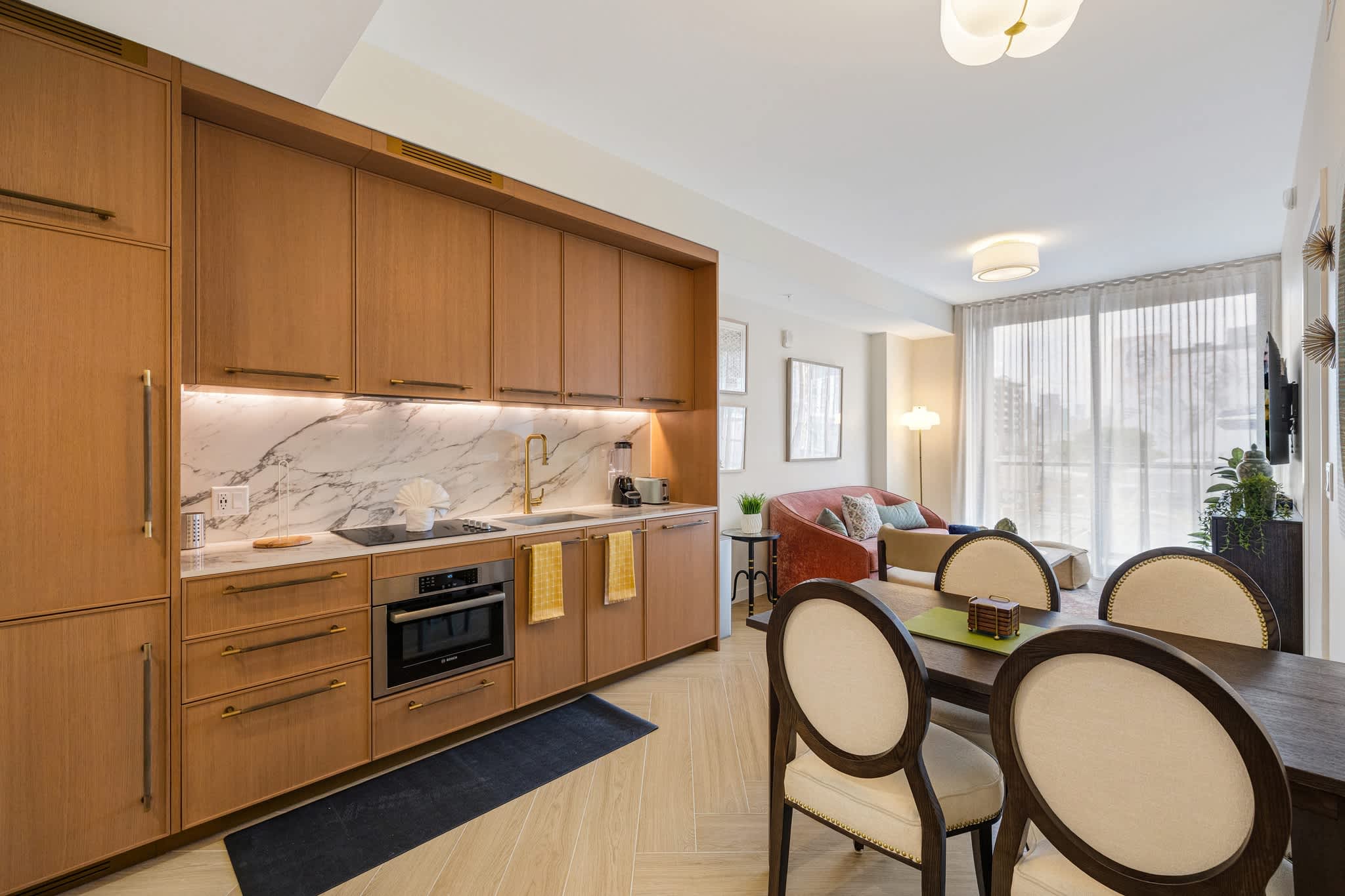 Experience modern living in this stylish studio with a sleek kitchen and cozy seating area, perfect for a relaxing stay.