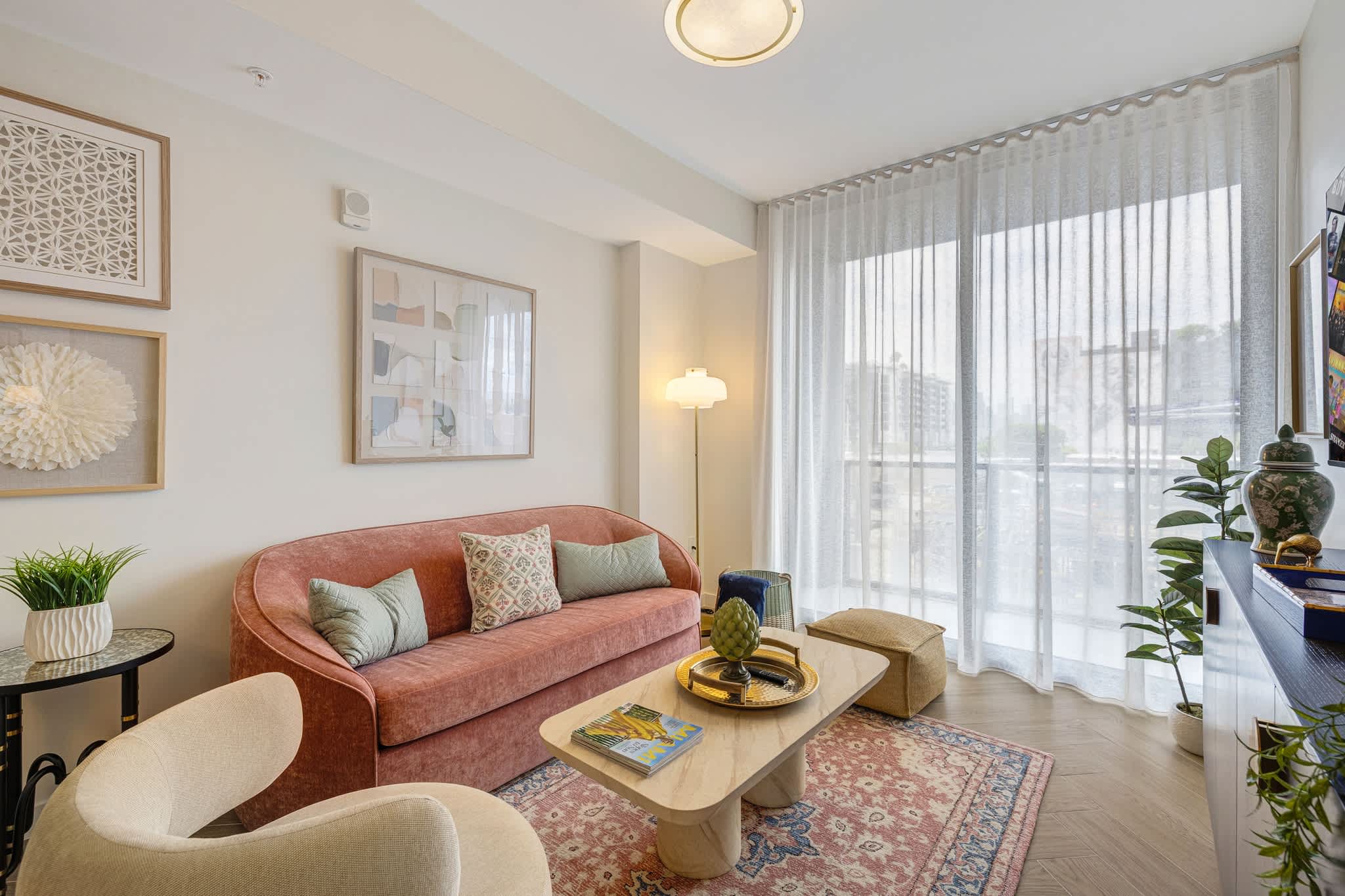 Cozy and stylish living room with chic decor and ample natural light, perfect for relaxation.