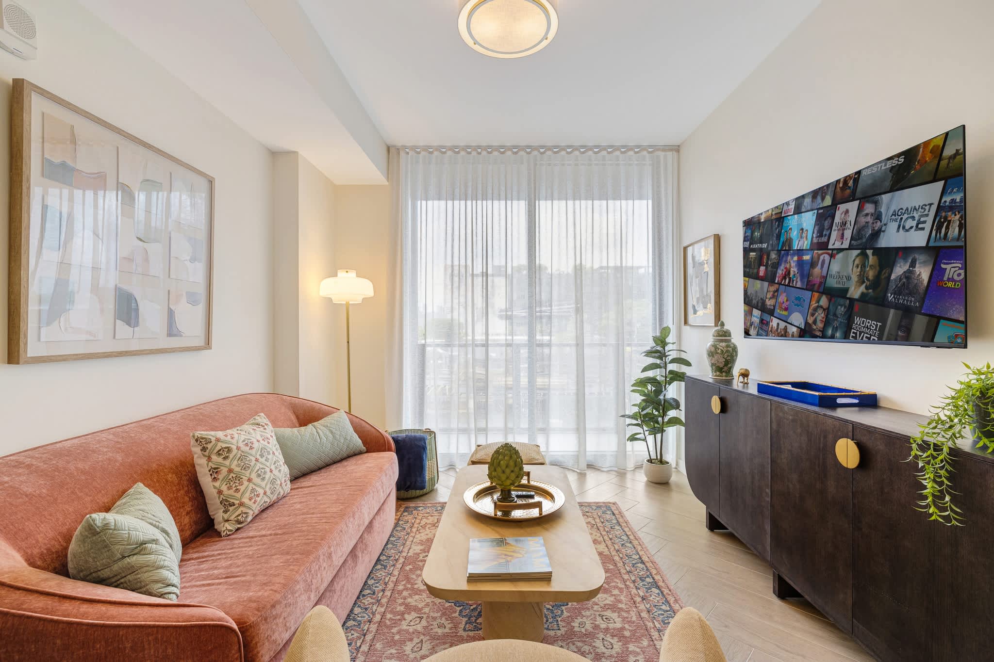 Relax in a chic living area with a plush sofa, modern decor, and a large TV for entertainment. Perfect for unwinding after a day of exploring.