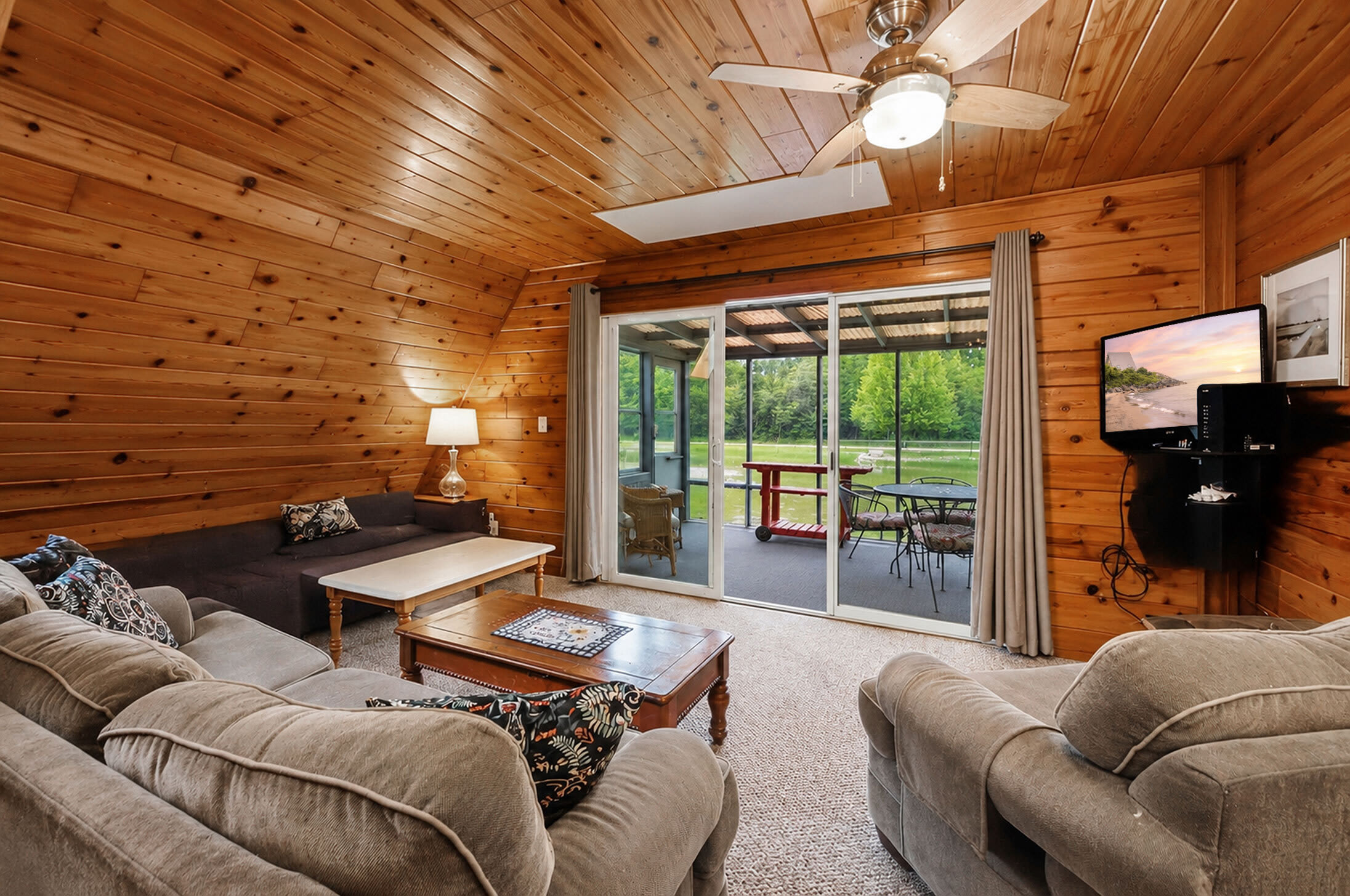 Relax in the living room with seamless access to the screened porch.