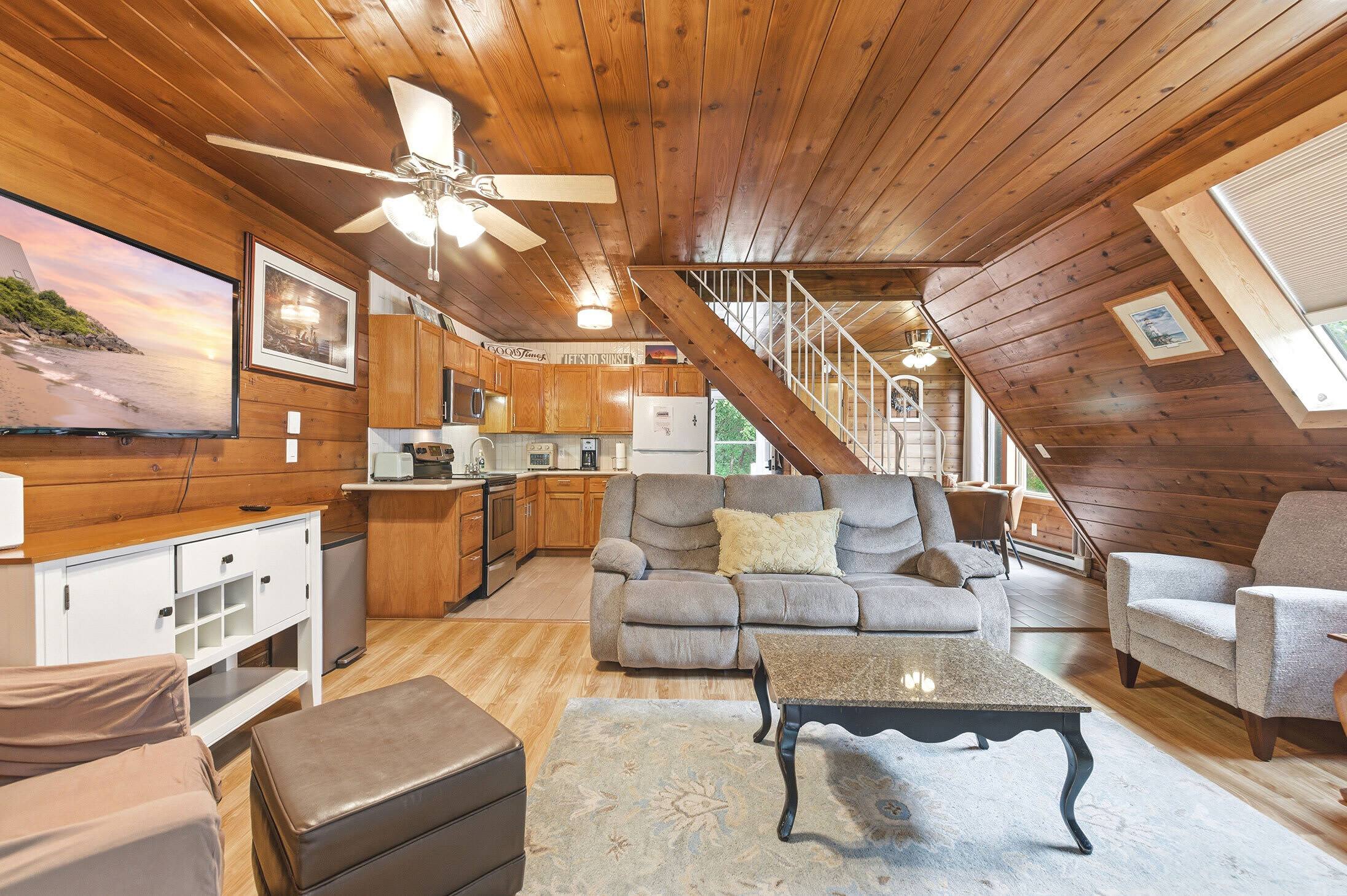 The open layout keeps the kitchen, dining, and living spaces connected.