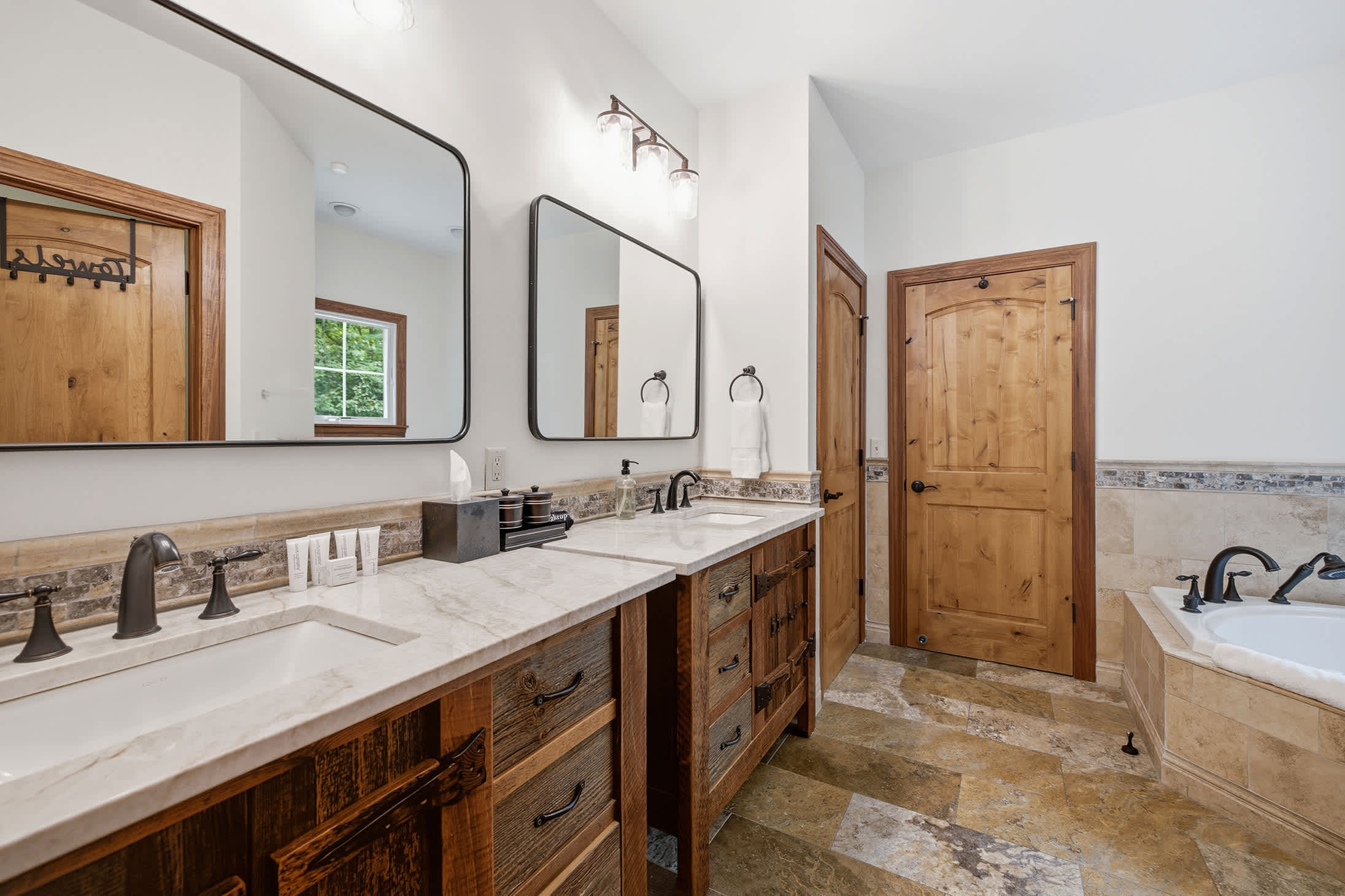 Primary bathroom with soaking tub and dual vanities adds everyday comfort.