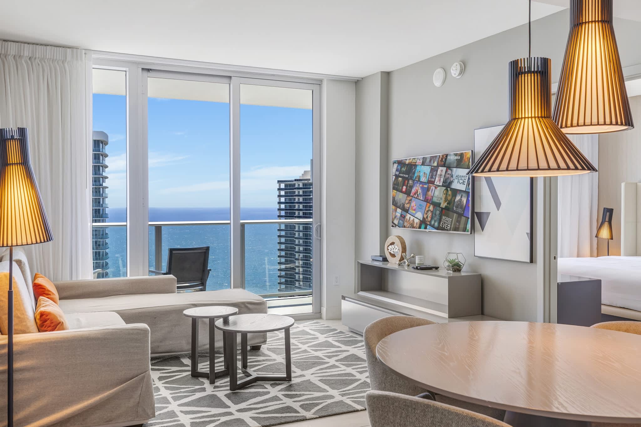 Relax in a stylish living room with stunning ocean views and modern comforts.