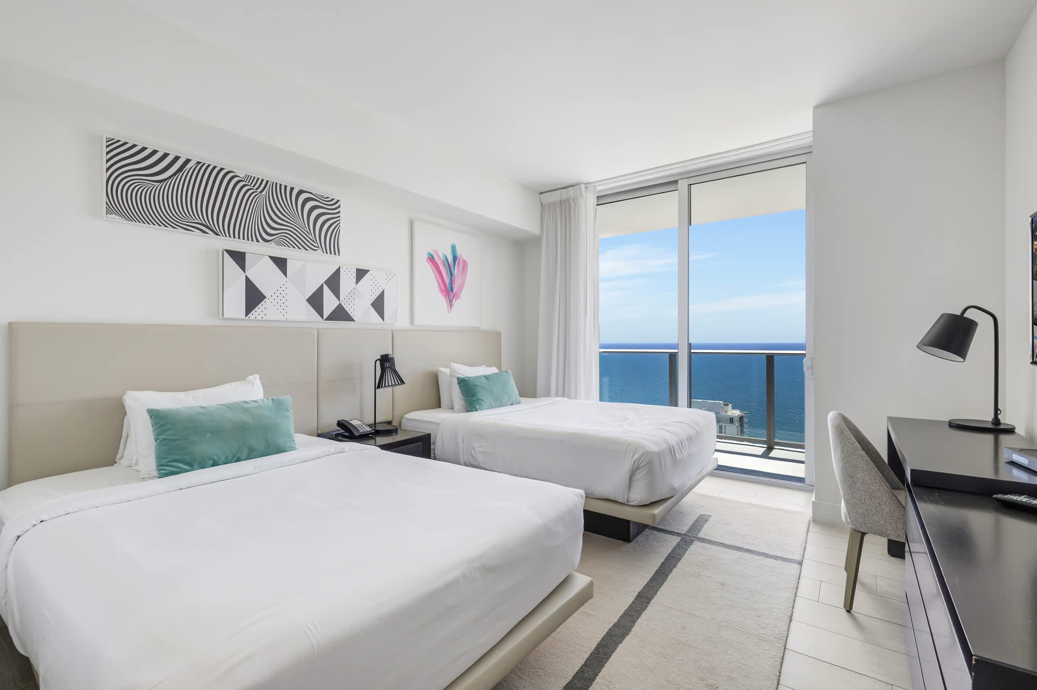 Relax in this stylish bedroom with two plush beds and a breathtaking ocean view from your private balcony.