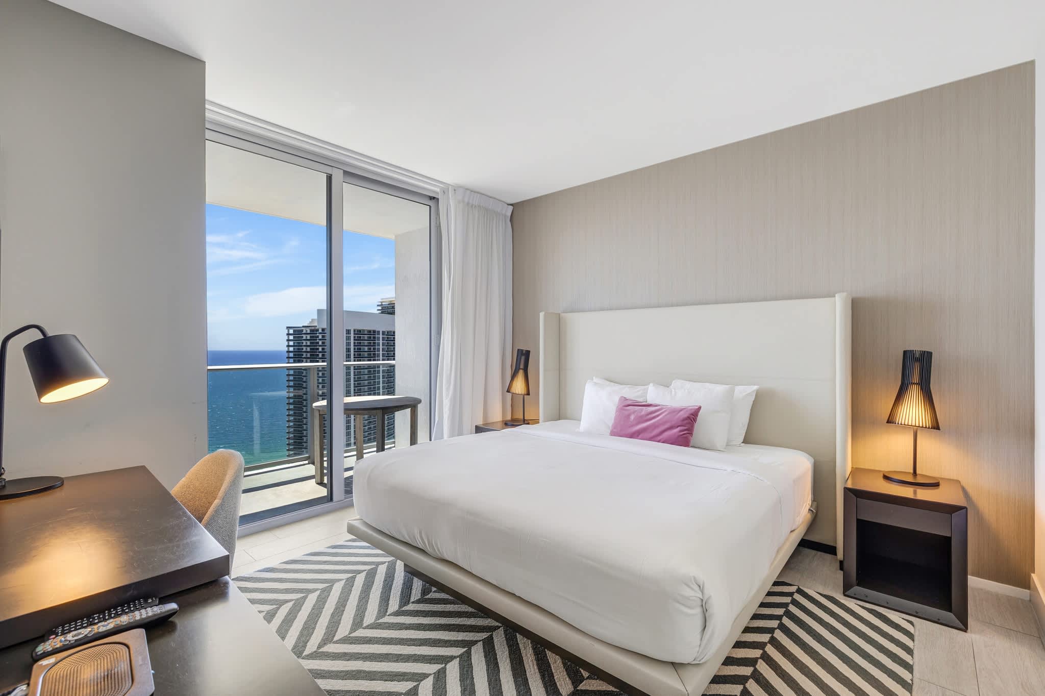 Relax in this stylish bedroom with stunning ocean views and modern amenities, perfect for a serene getaway.