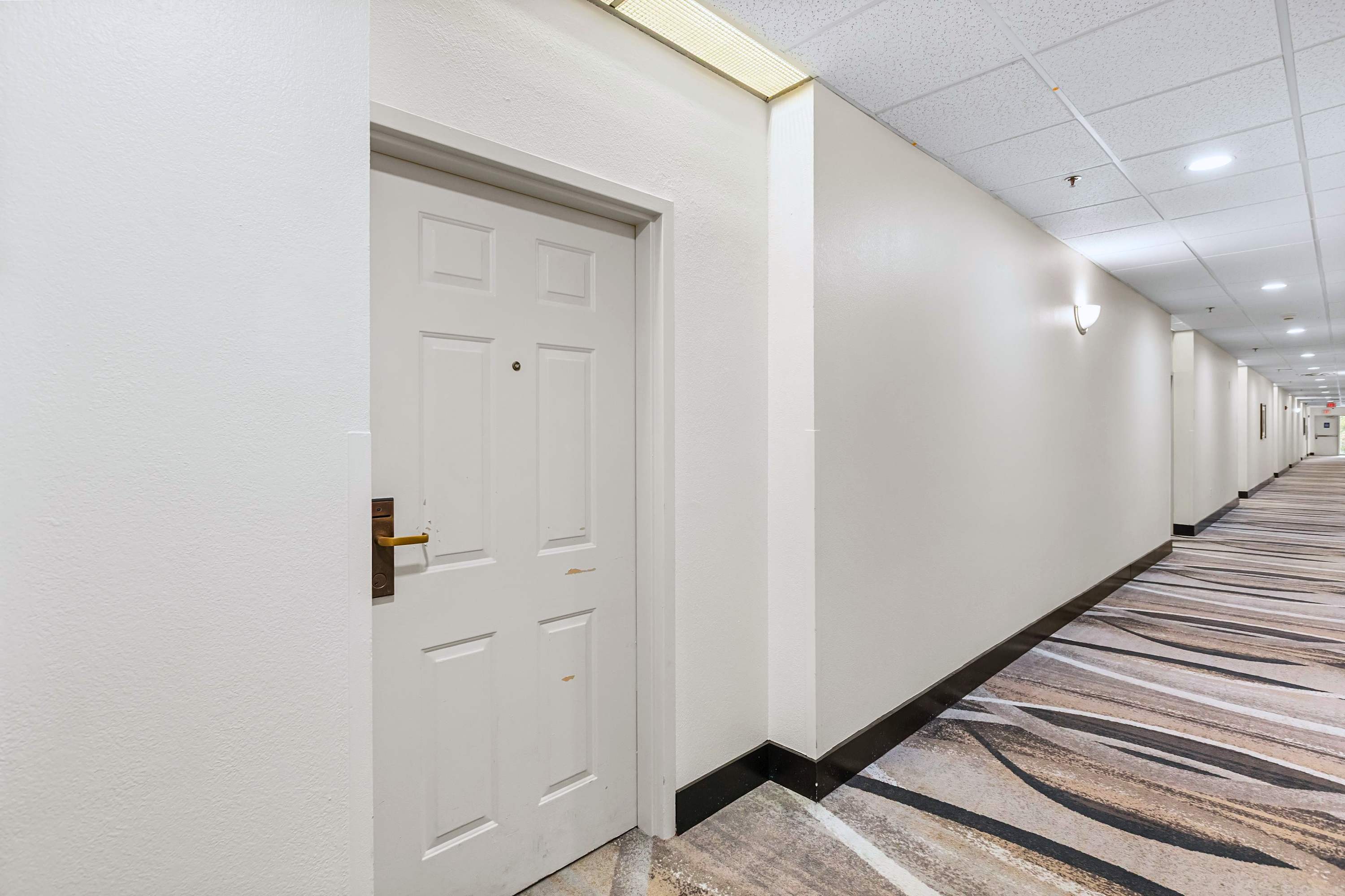 Clean, matted hallway providing a peaceful entrance to your stay.