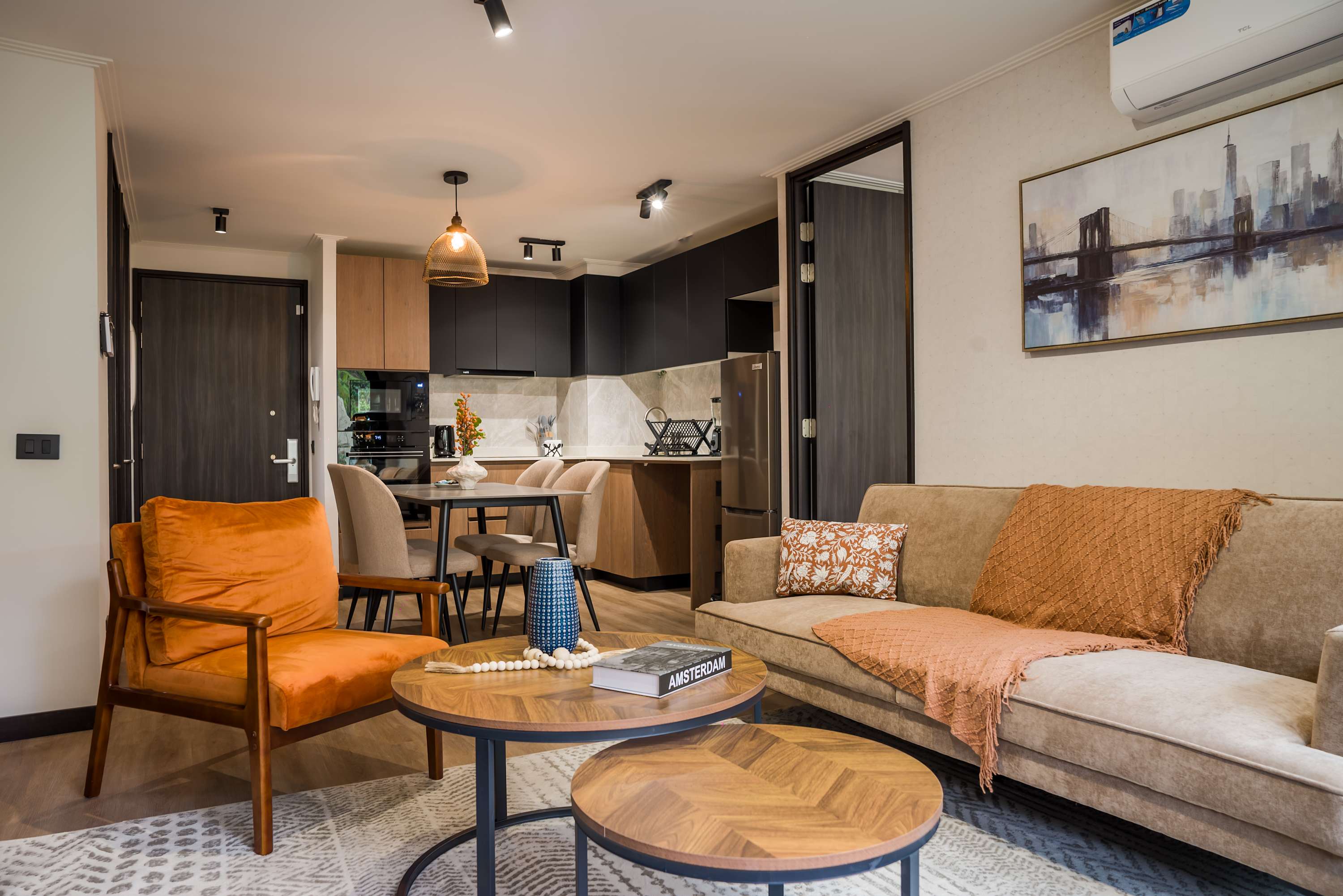 Relax in this stylish living area with a cozy sofa and modern kitchen, perfect for unwinding after exploring the city.
