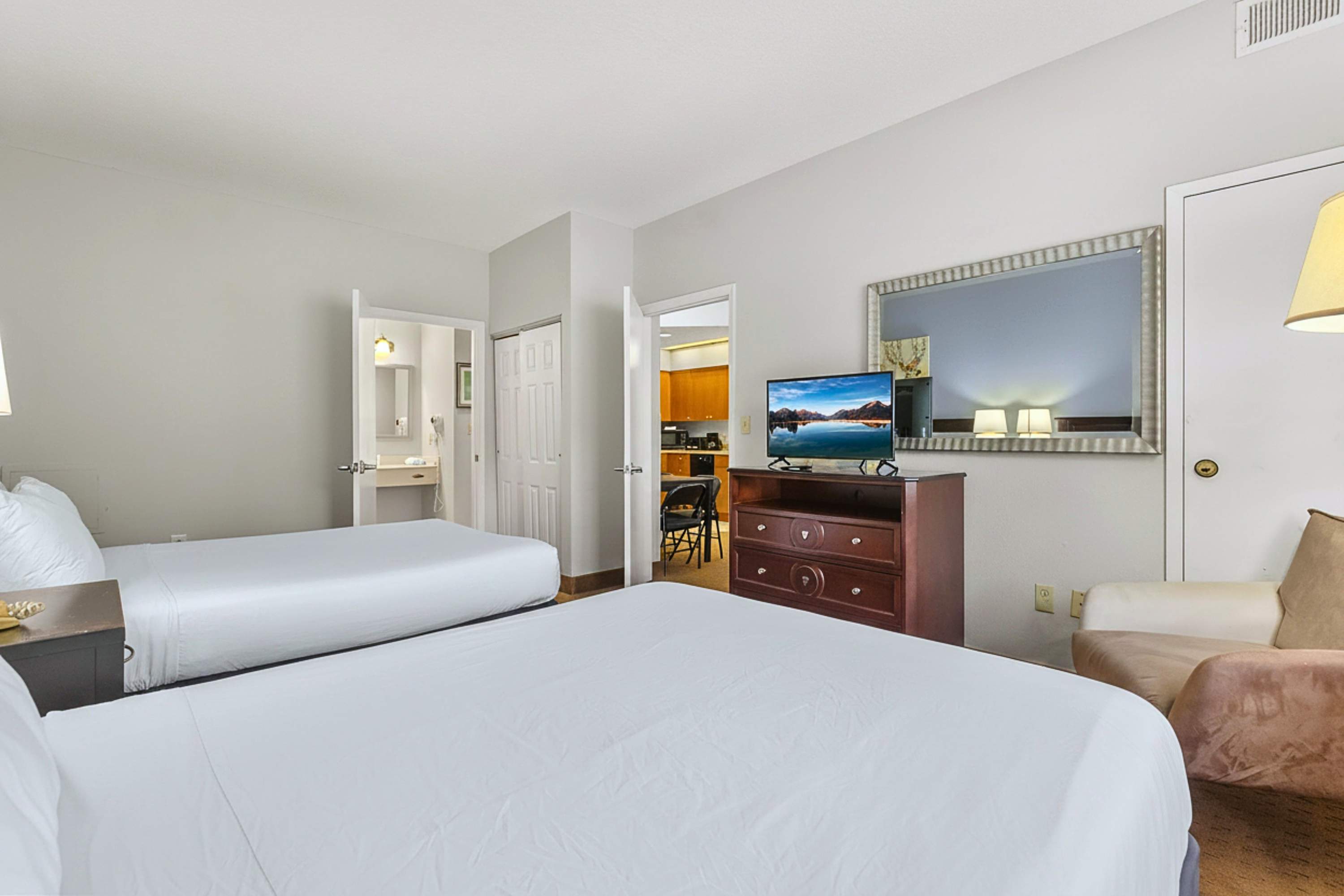 Relax in style! Two queen beds, smart TV, side couch, and easy bath access