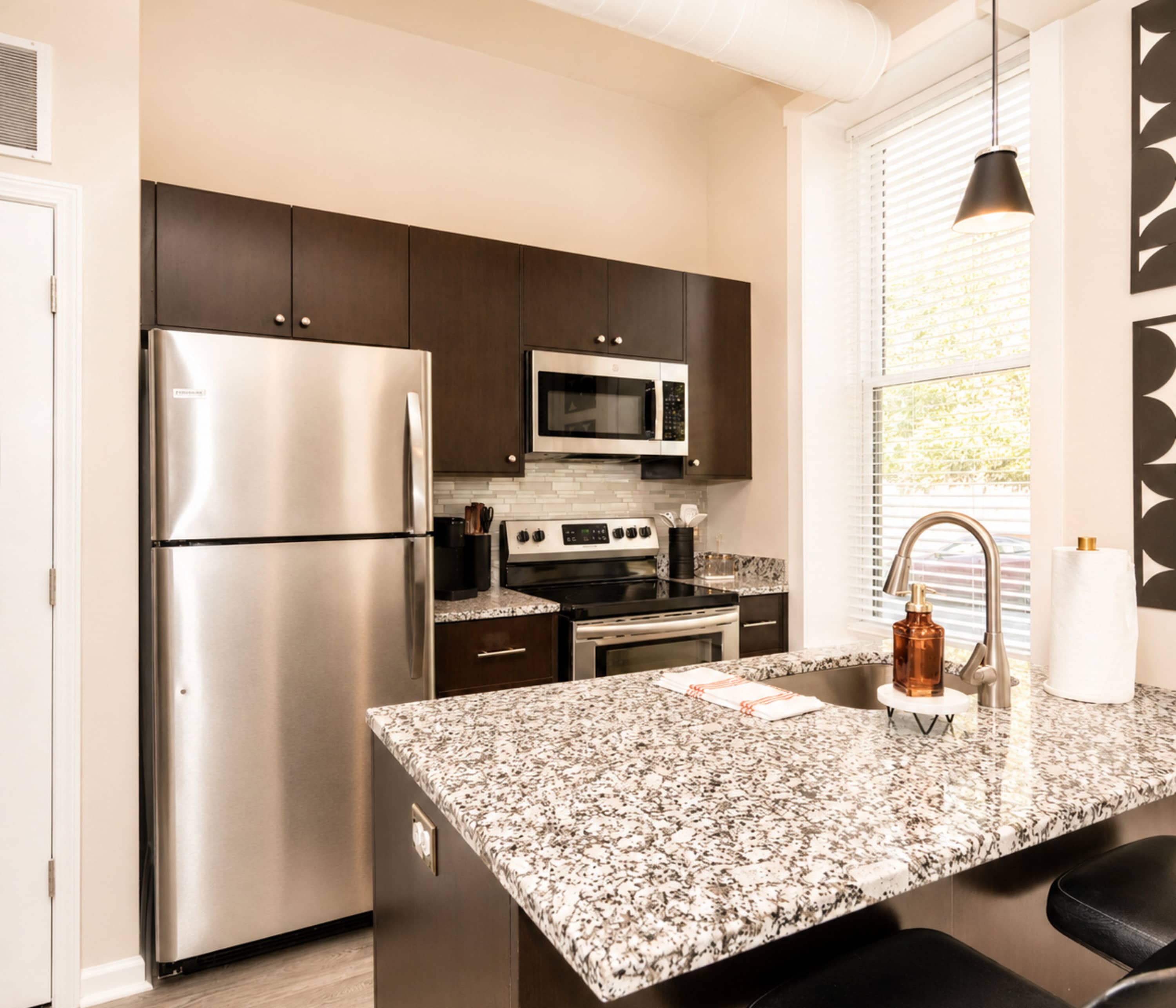The sleek, open kitchen offers ample space & every home comfort