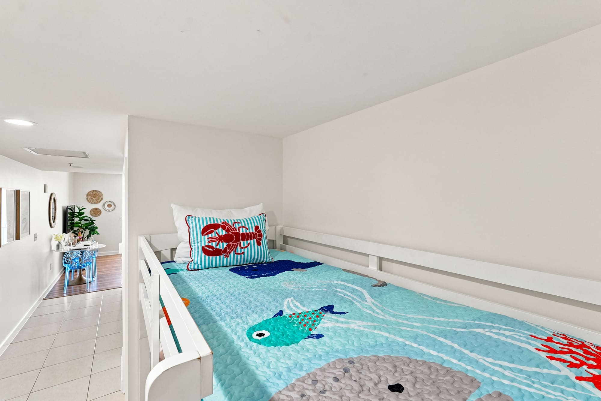 Splash 804E – Lofted bedroom area with colorful fish-themed bedding and adjoining open space.