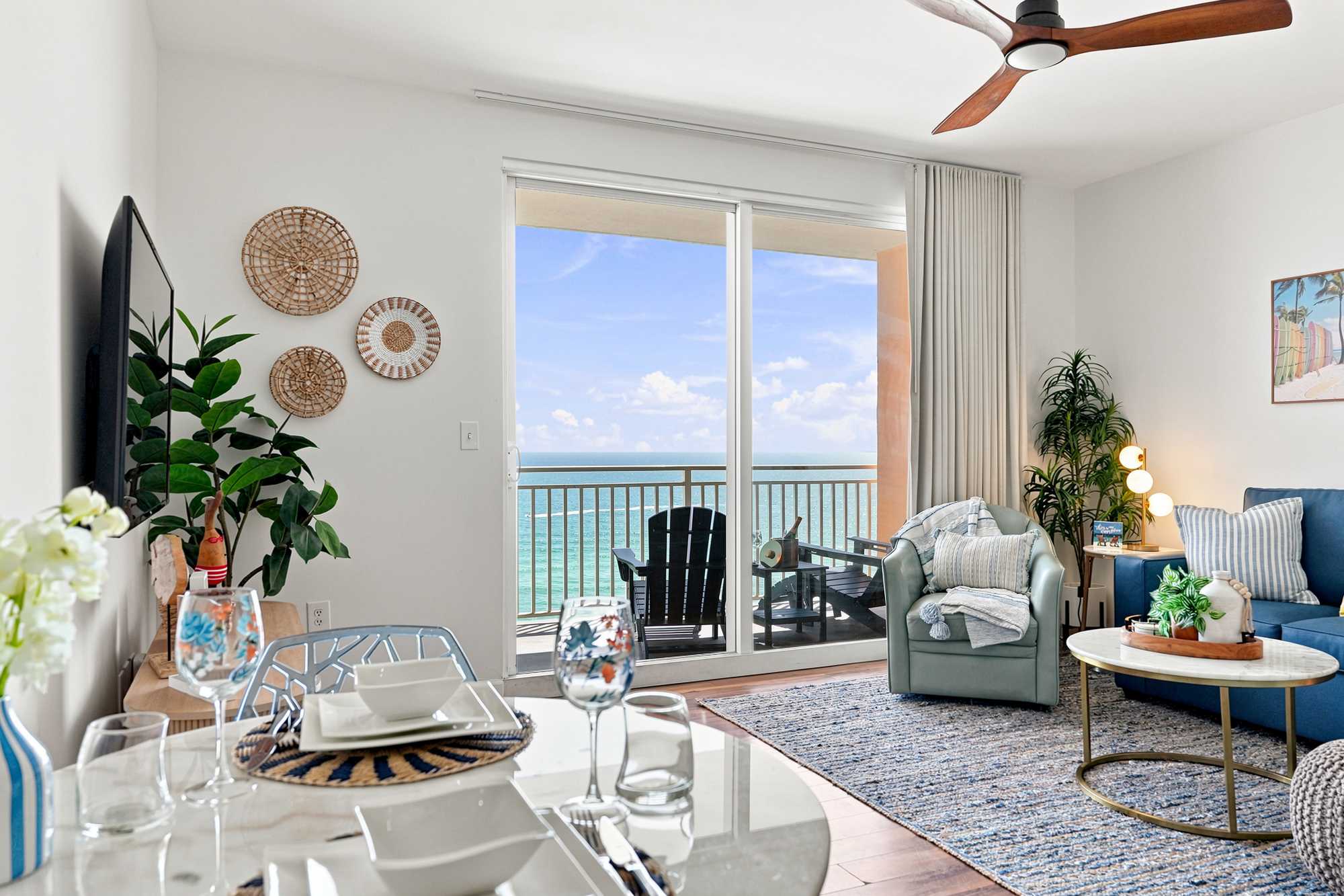 Splash 804E – Bright living area with ocean view, large windows, seating, and dining setup.
