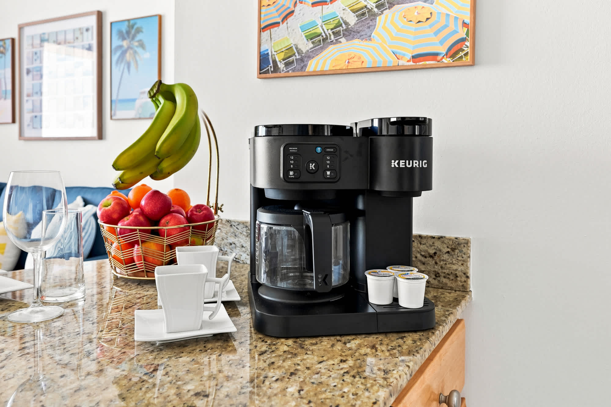 Splash 804E – Breakfast bar with coffee maker, fruit bowl, and white cups on a granite countertop.