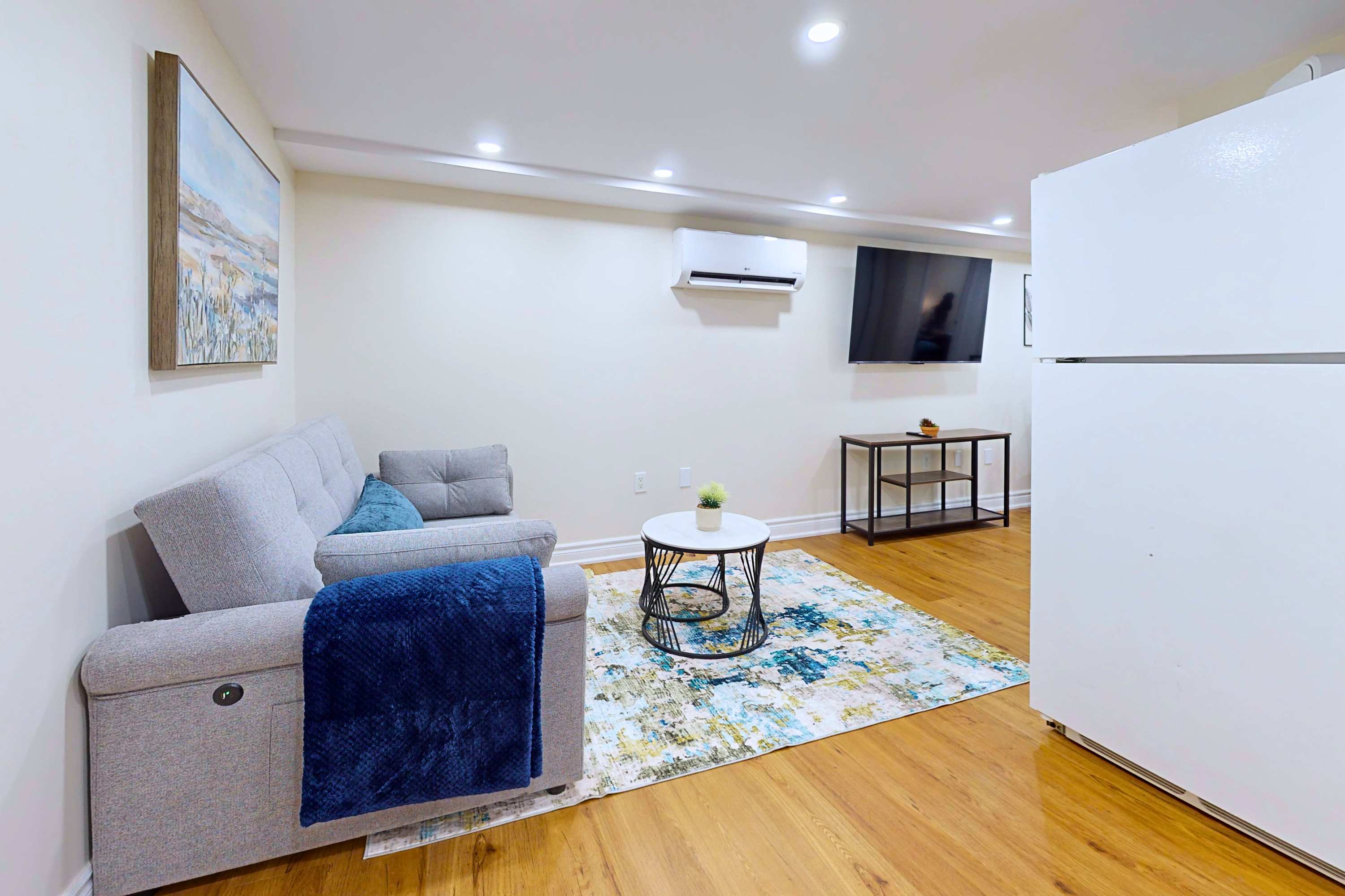 Cool and comfortable lounge area with sofa, coffee table, and TV