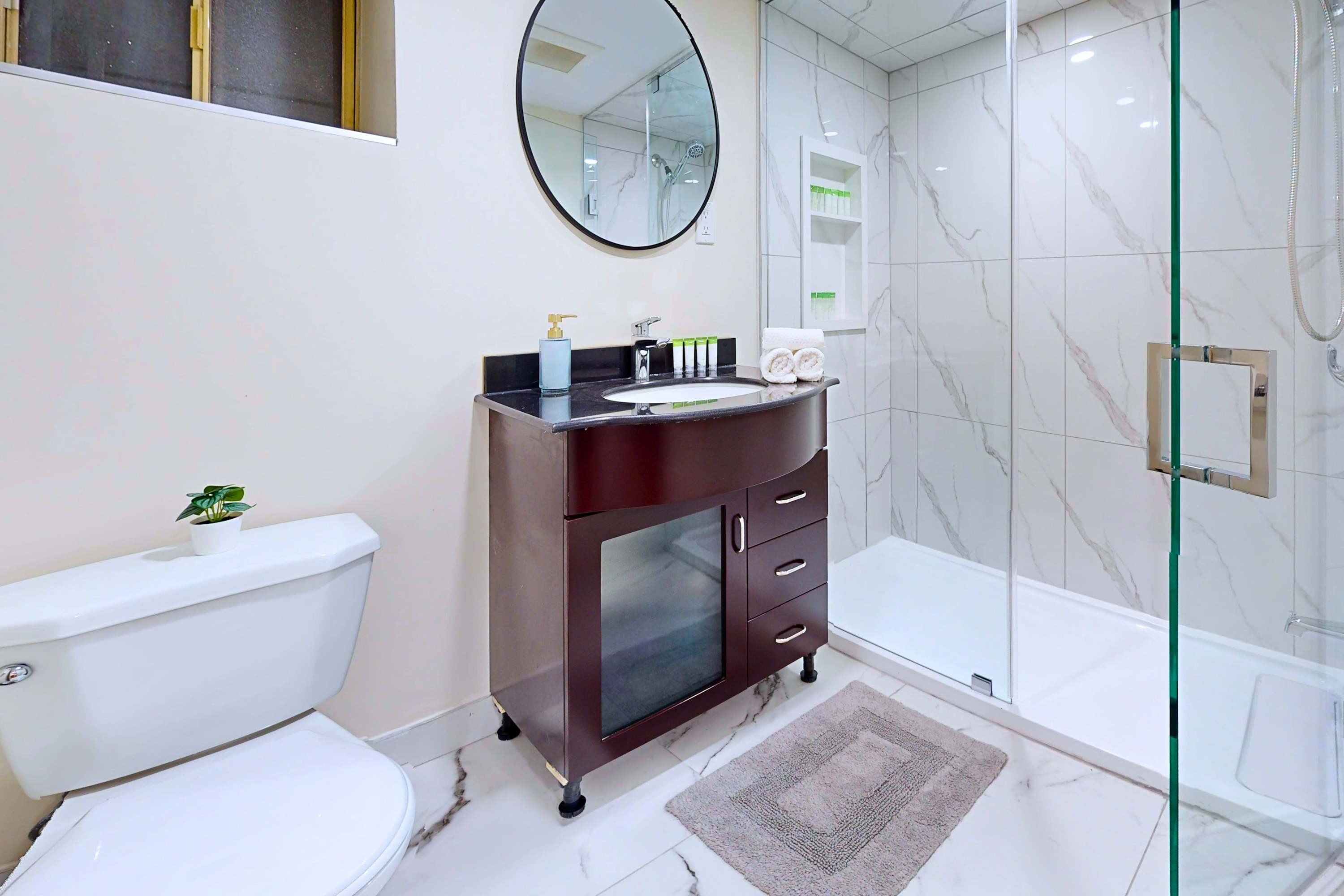 Clean bathroom featuring a walk-in shower and mirrored sink cabinet.