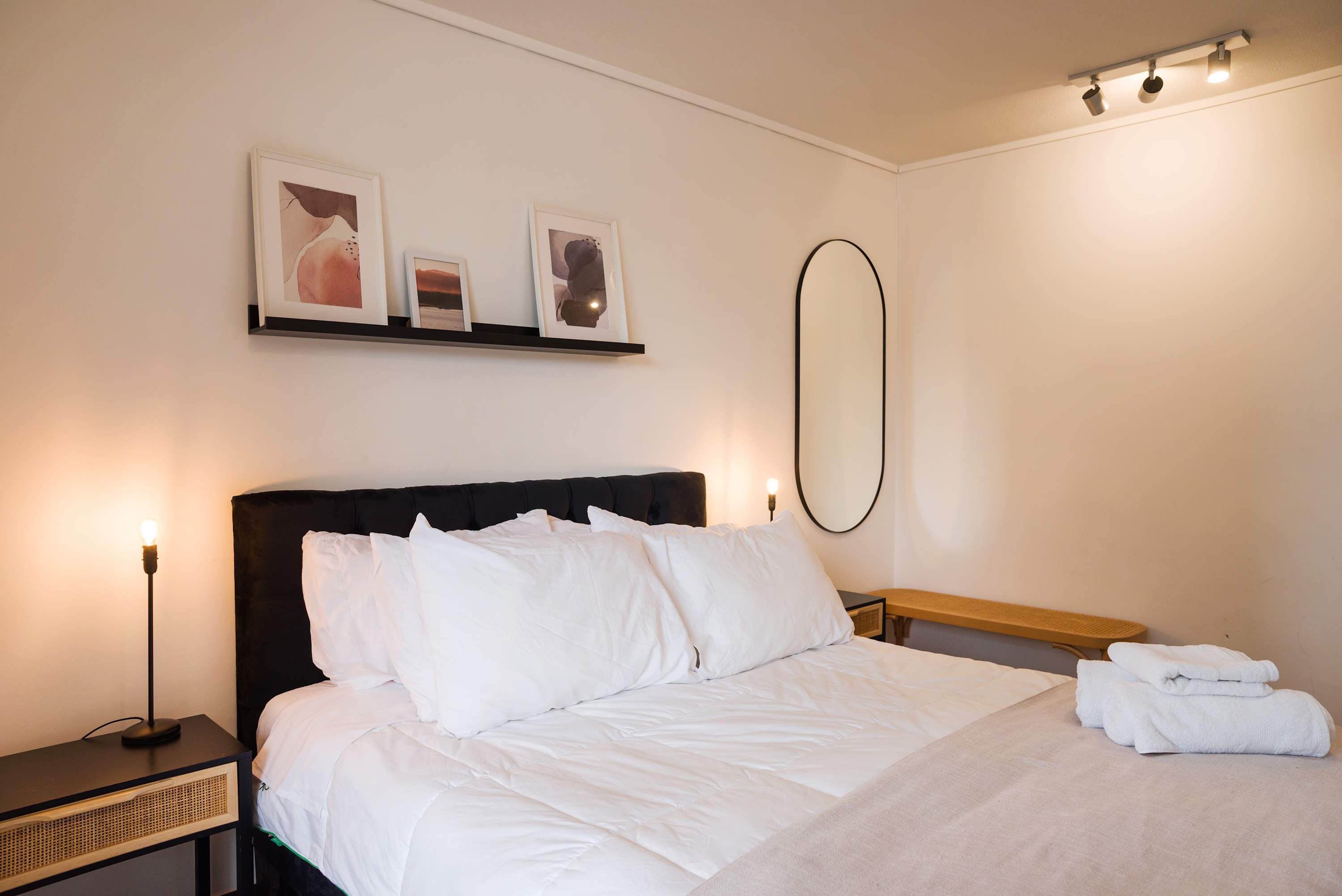 Relax in this stylish bedroom featuring modern decor and cozy bedding, perfect for a restful stay.