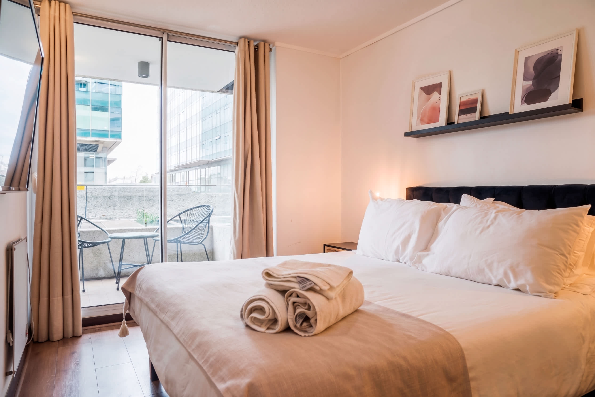 Relax in this cozy bedroom with a private balcony, perfect for enjoying city views and fresh air.