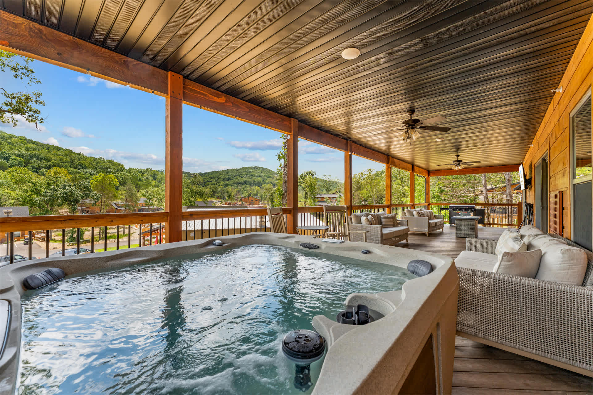 Bask in bubbling bliss with water views in the back deck’s private hot tub​