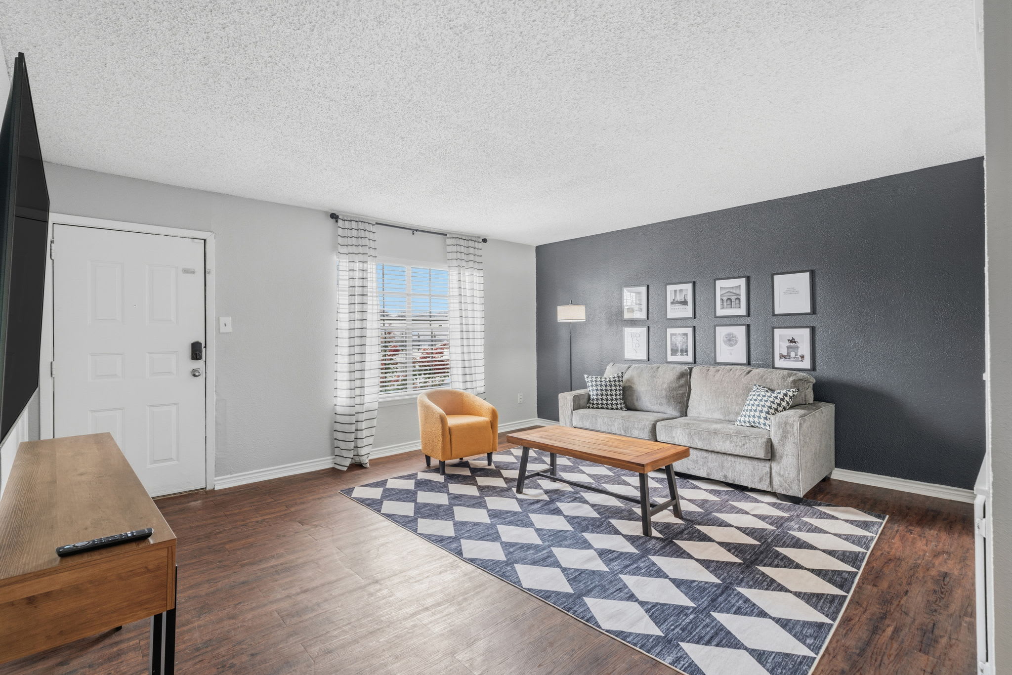 Spacious and bright living room with stylish decor, perfect for unwinding after a day of exploring.