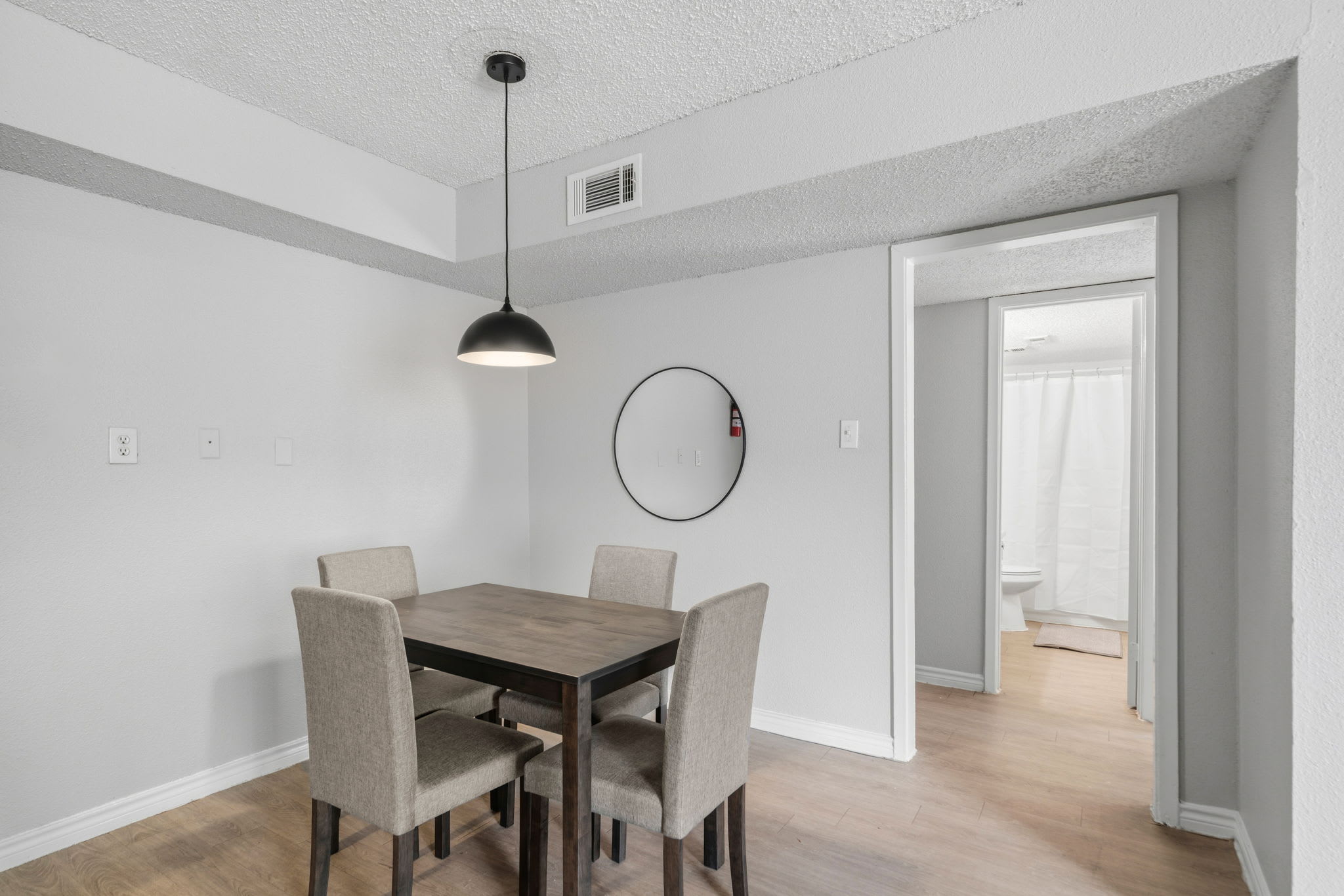 Cozy dining area perfect for intimate meals, featuring a modern table and stylish pendant lighting.