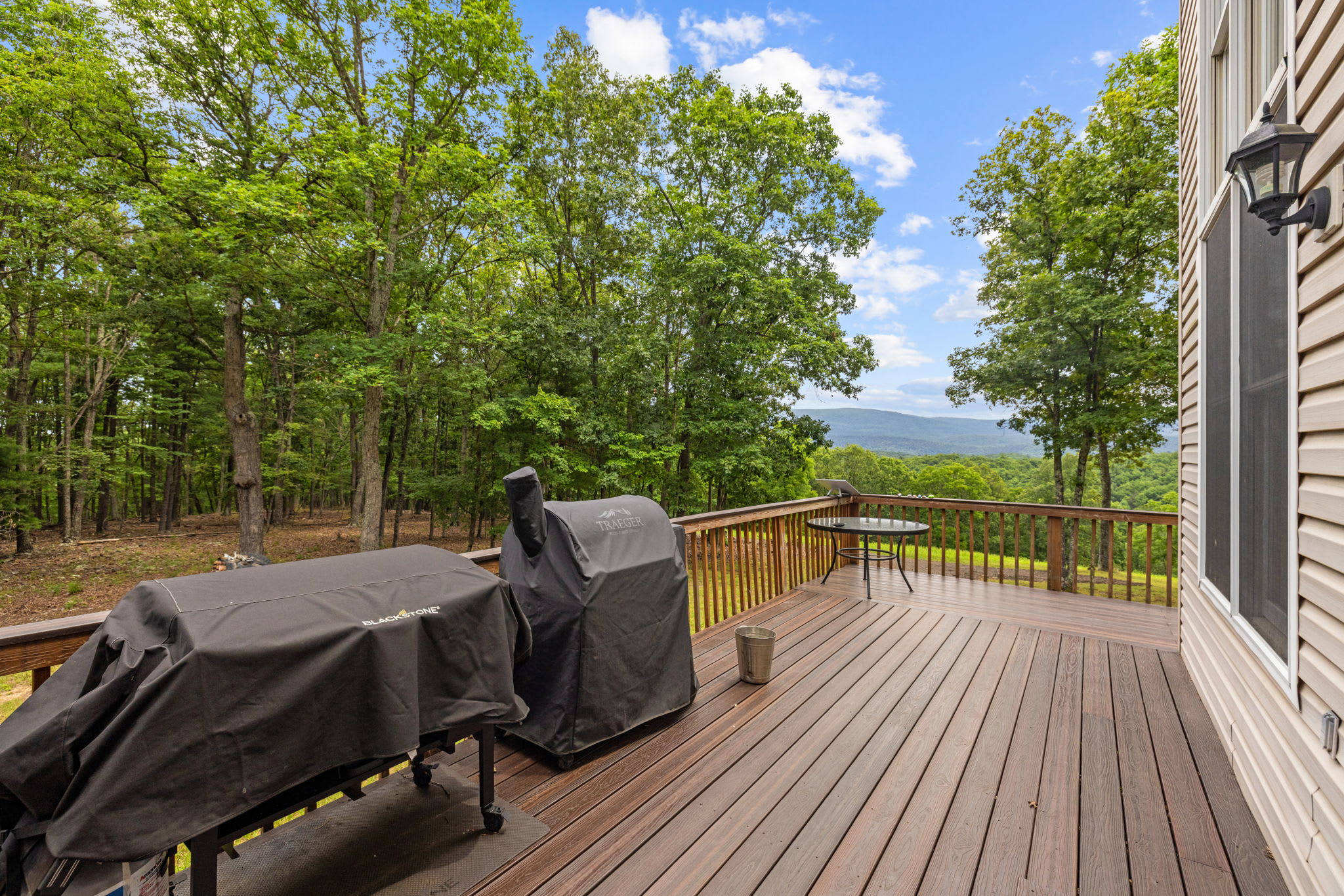 Spacious deck with a propane grill and smoker—perfect for outdoor dining