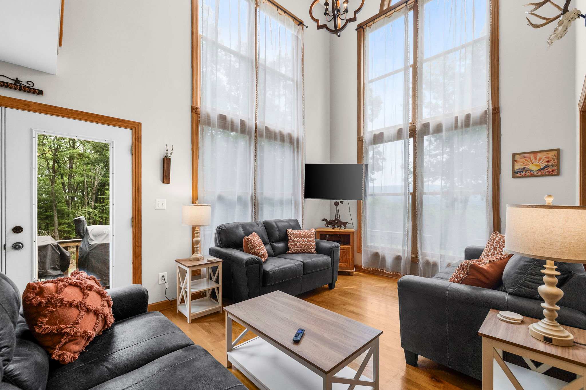 Open-concept living area with a cozy wood-burning fireplace, ideal for gathering
