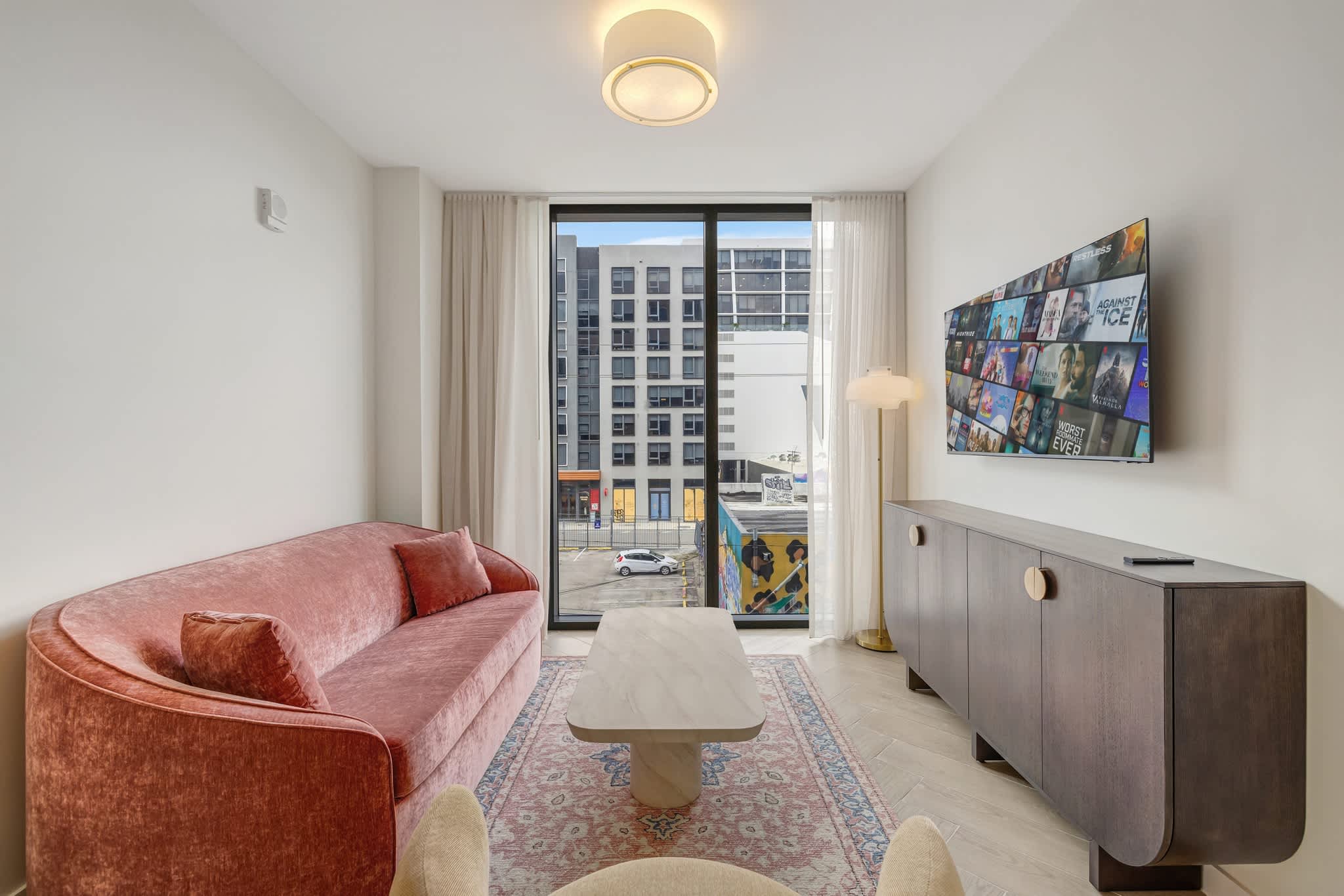 Relax in a chic living room with city views, plush seating, and modern amenities.