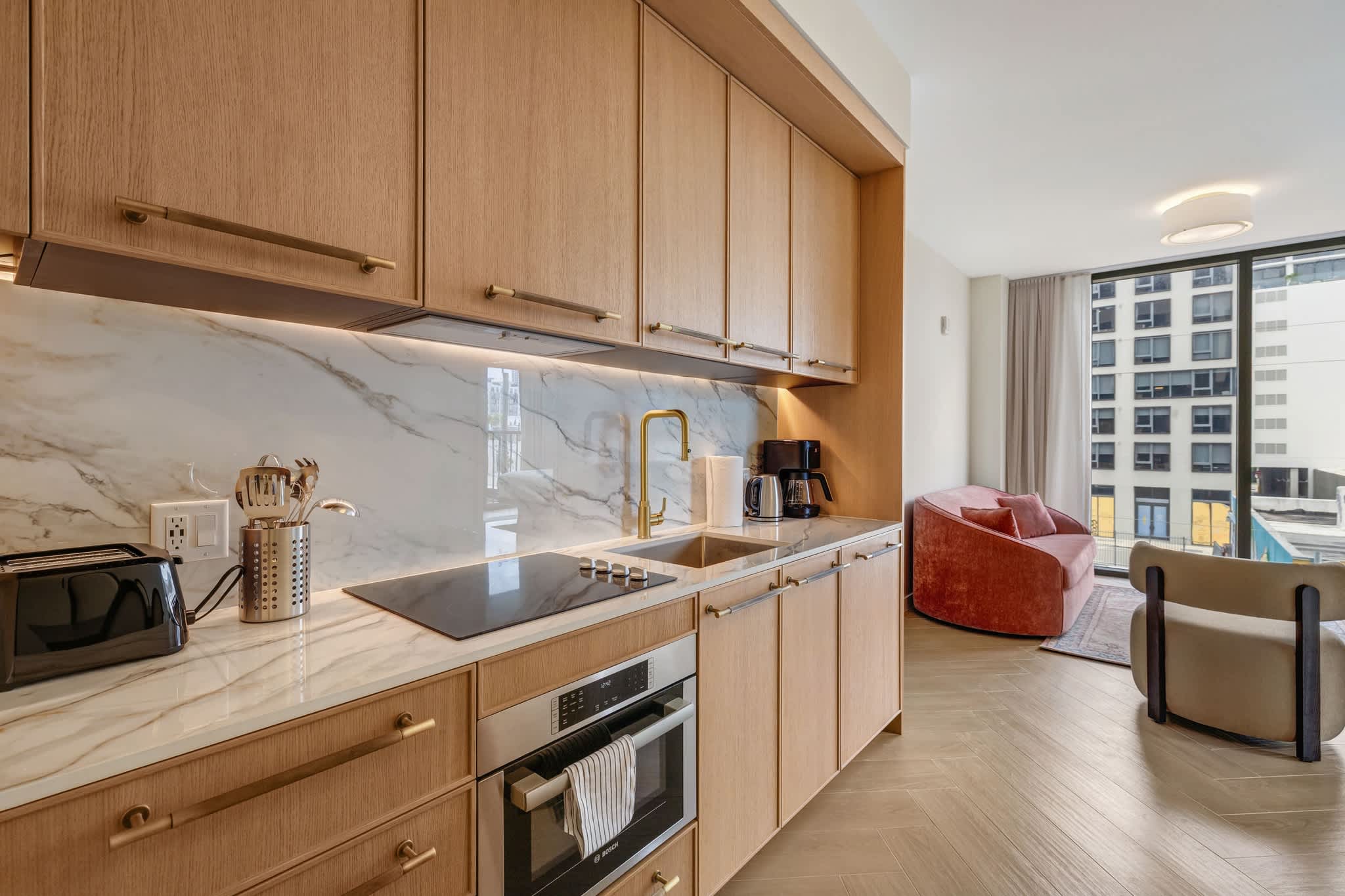 Experience modern elegance in this stylish kitchen with city views, perfect for cooking and relaxing.